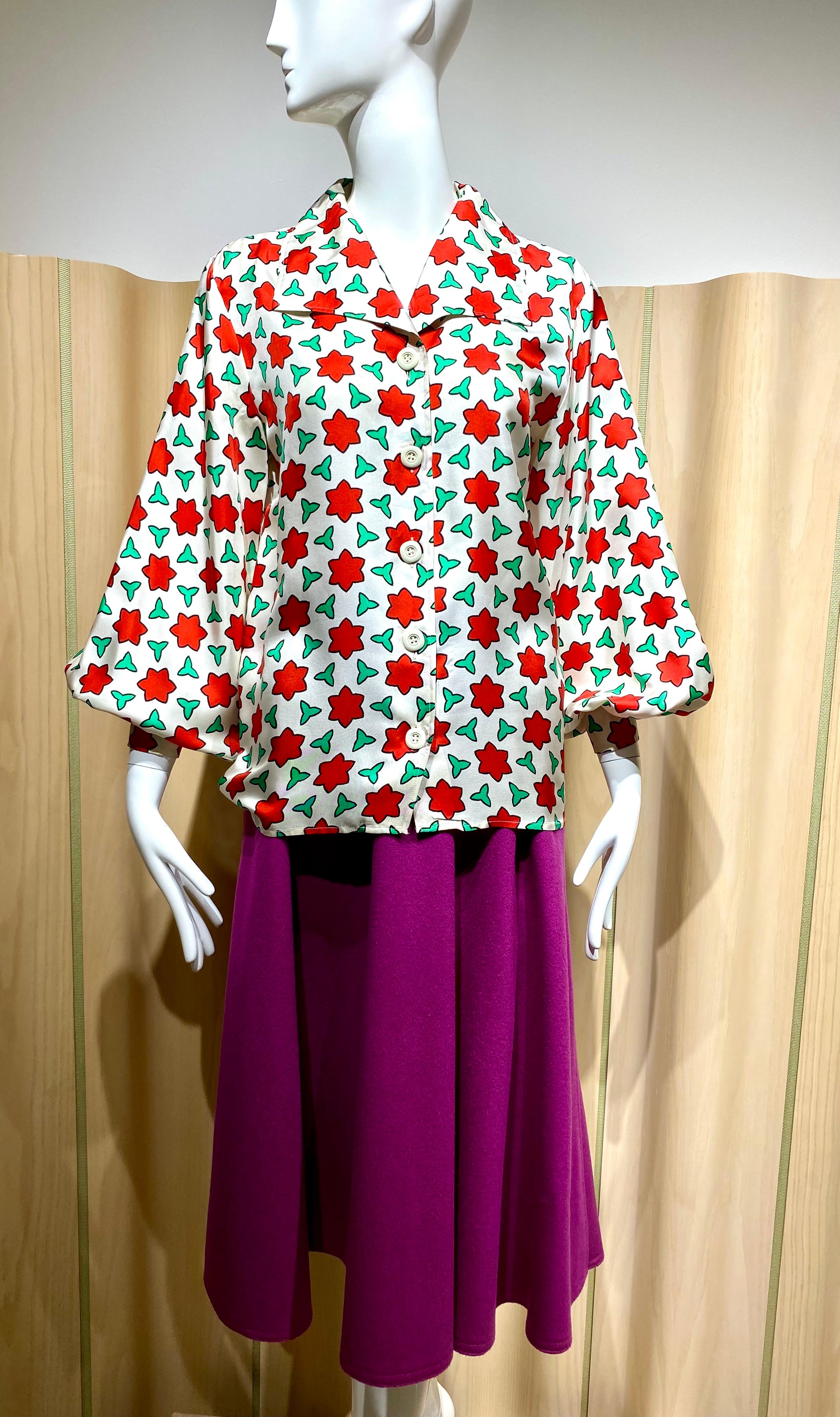 Vintage 70s Saint Laurent rive gauche white silk blouse in red and green stars print with puffy sleeves. Label marked size : 34
Bust: 38”
Size : 4/6