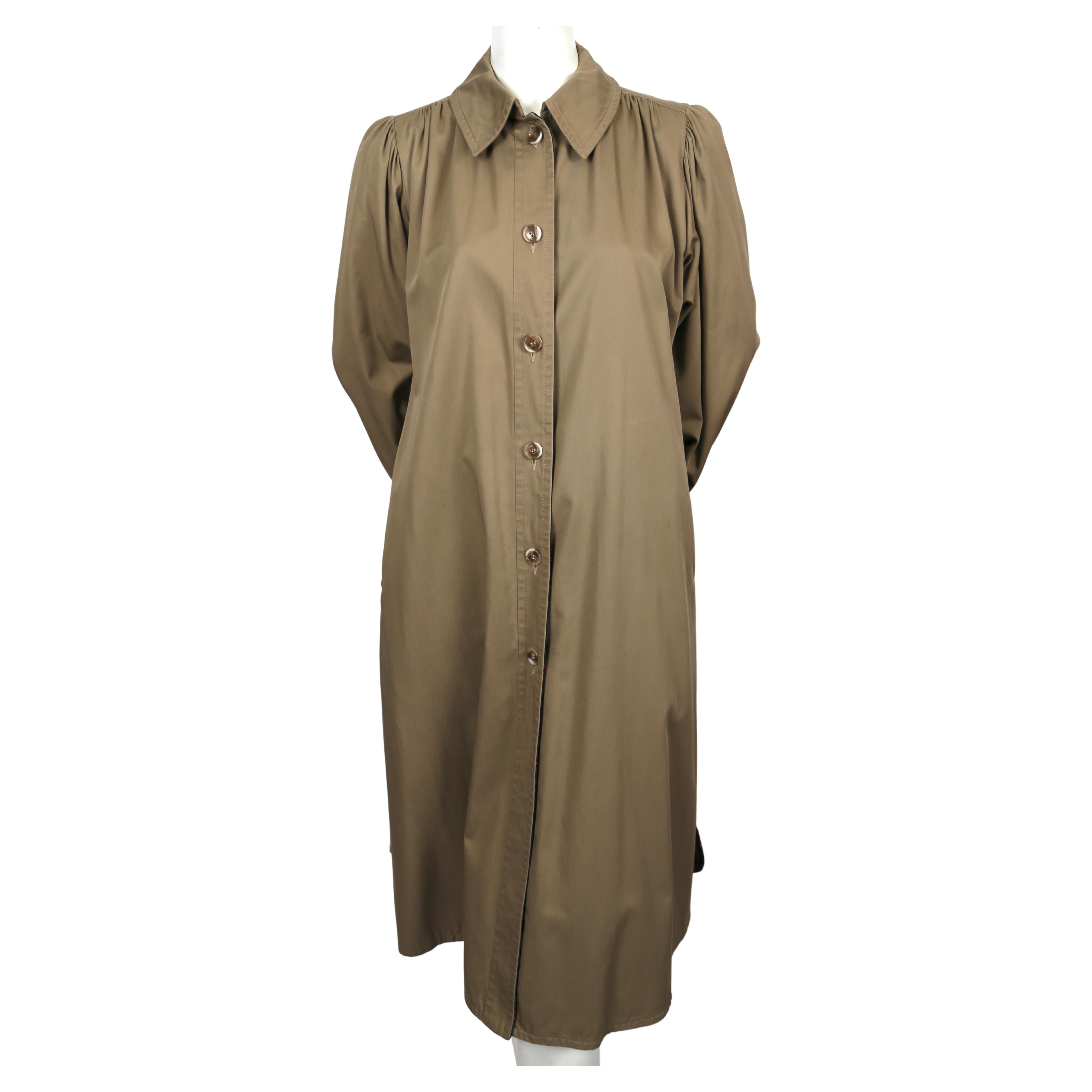 Classic, khaki-cotton trench coat with puff sleeves and plaid lining designed by Yves Saint Laurent dating to the 1970's. No size is indicated however this will best fit a US 4-10.   Approximate measurements: shoulder 15