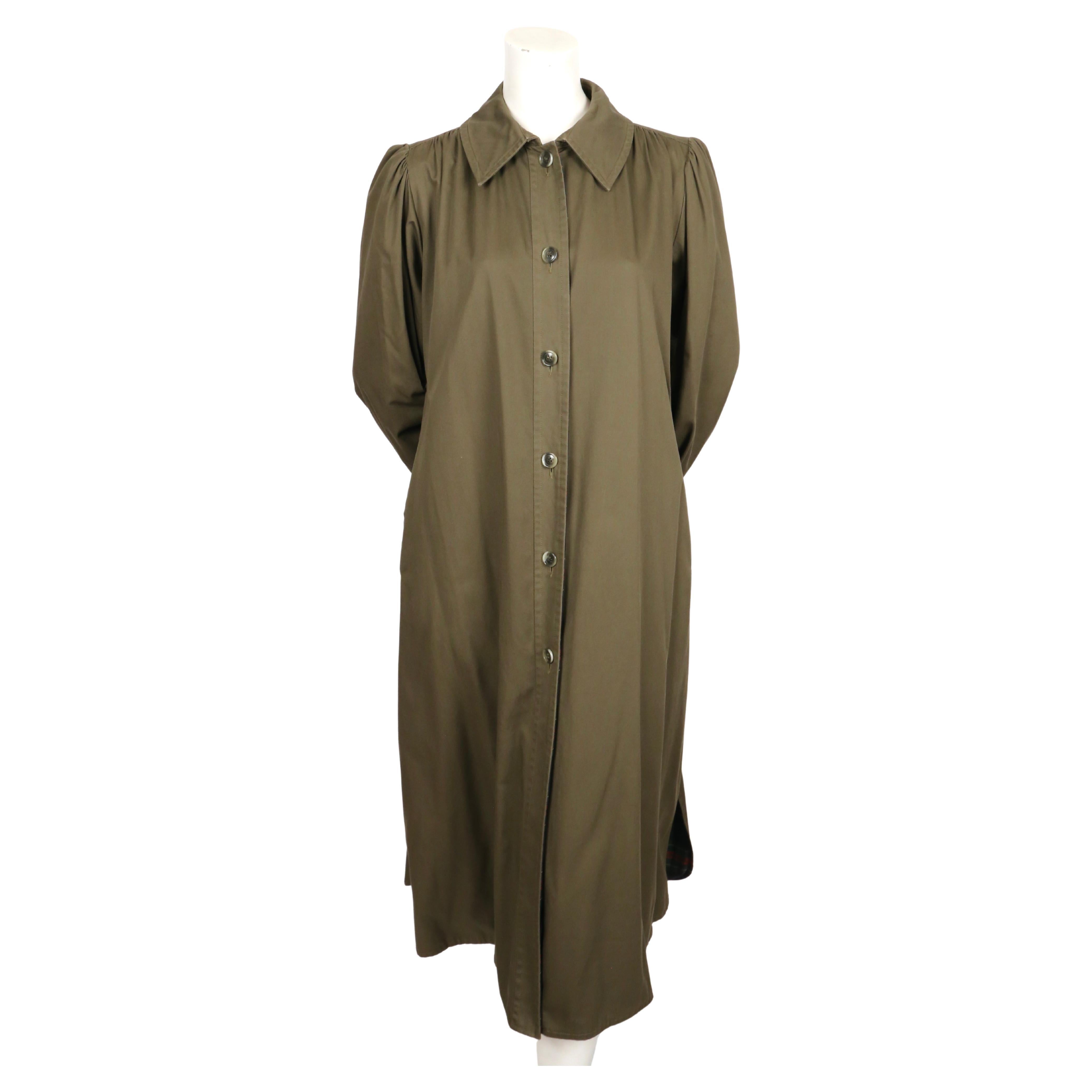Classic, army-green, cotton trench coat with puff sleeves and plaid lining designed by Yves Saint Laurent dating to the 1970's. No size is indicated however this will best fit a US 6-10.   Approximate measurements: shoulder 14,5