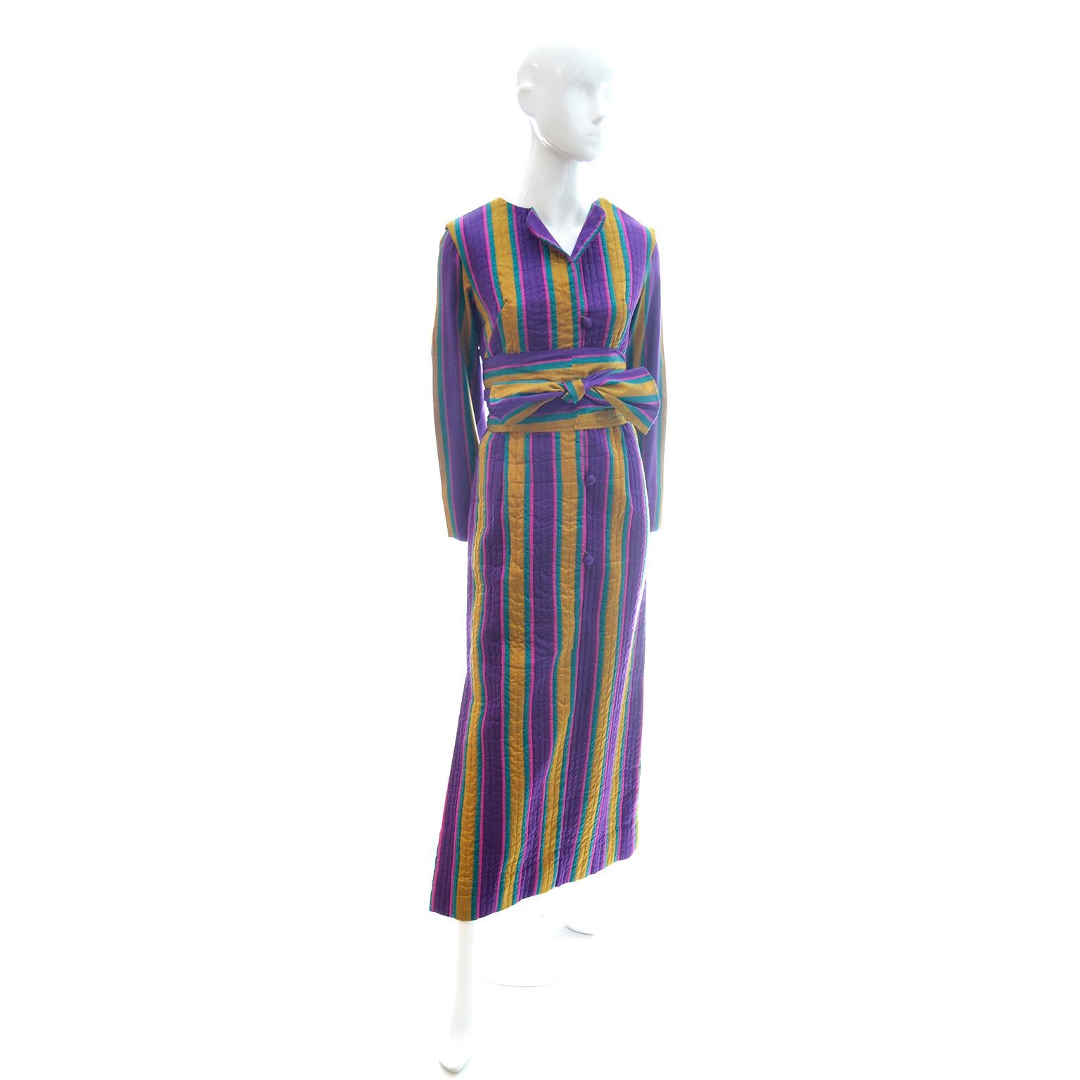 This is a lovely vintage silk caftan that was purchased from Saks Fifth Avenue in the 1970's. The striped 100% silk fabric is in beautiful shades of jewel tones including purple, teal / turquoise blue and gold. The body of the caftan is quilted with