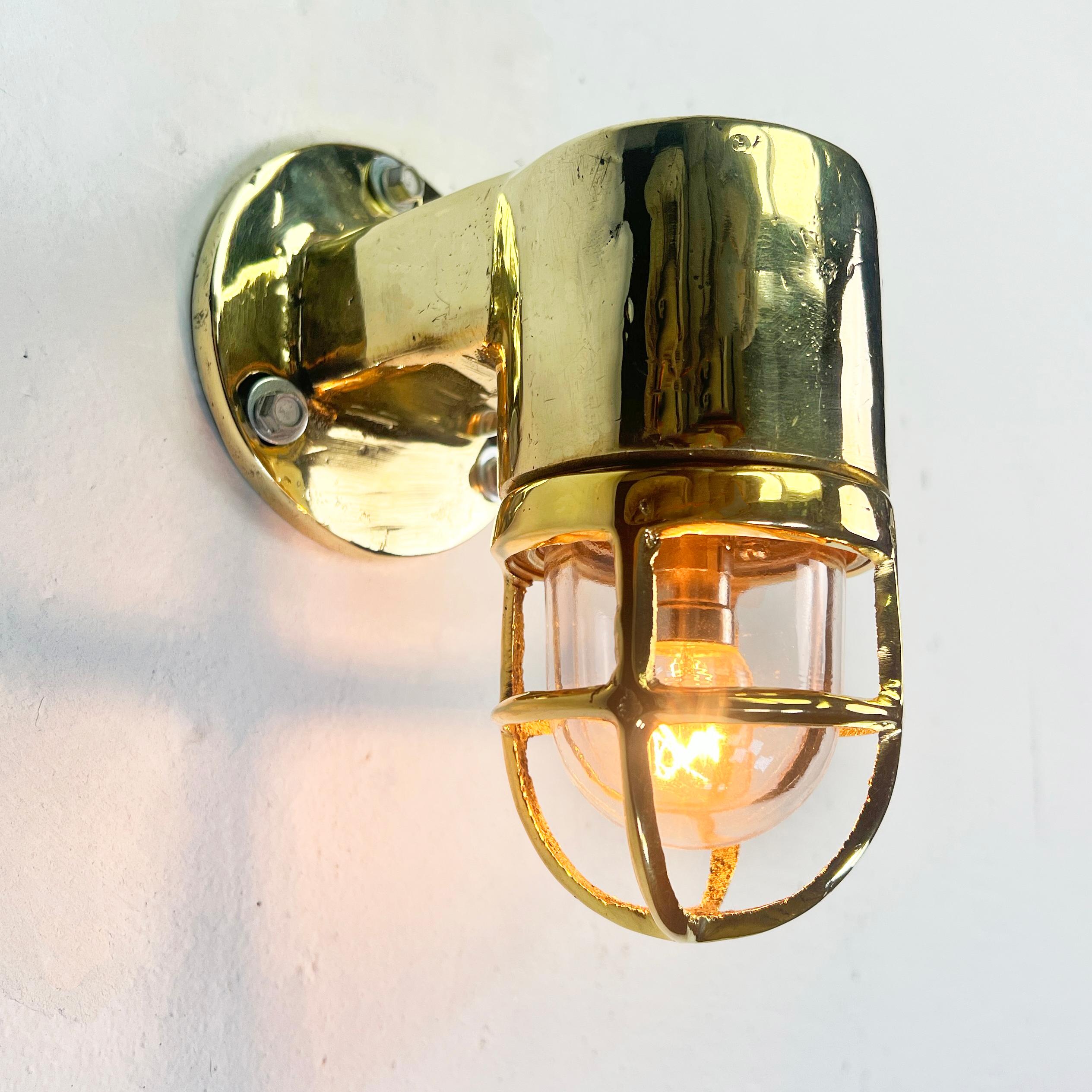 A small solid brass nautical wall light. Reclaimed from old ships and restored with new electrical components. These petite fixtures were designed for use in industrial environments so the quality is second to none with a cast brass construction and