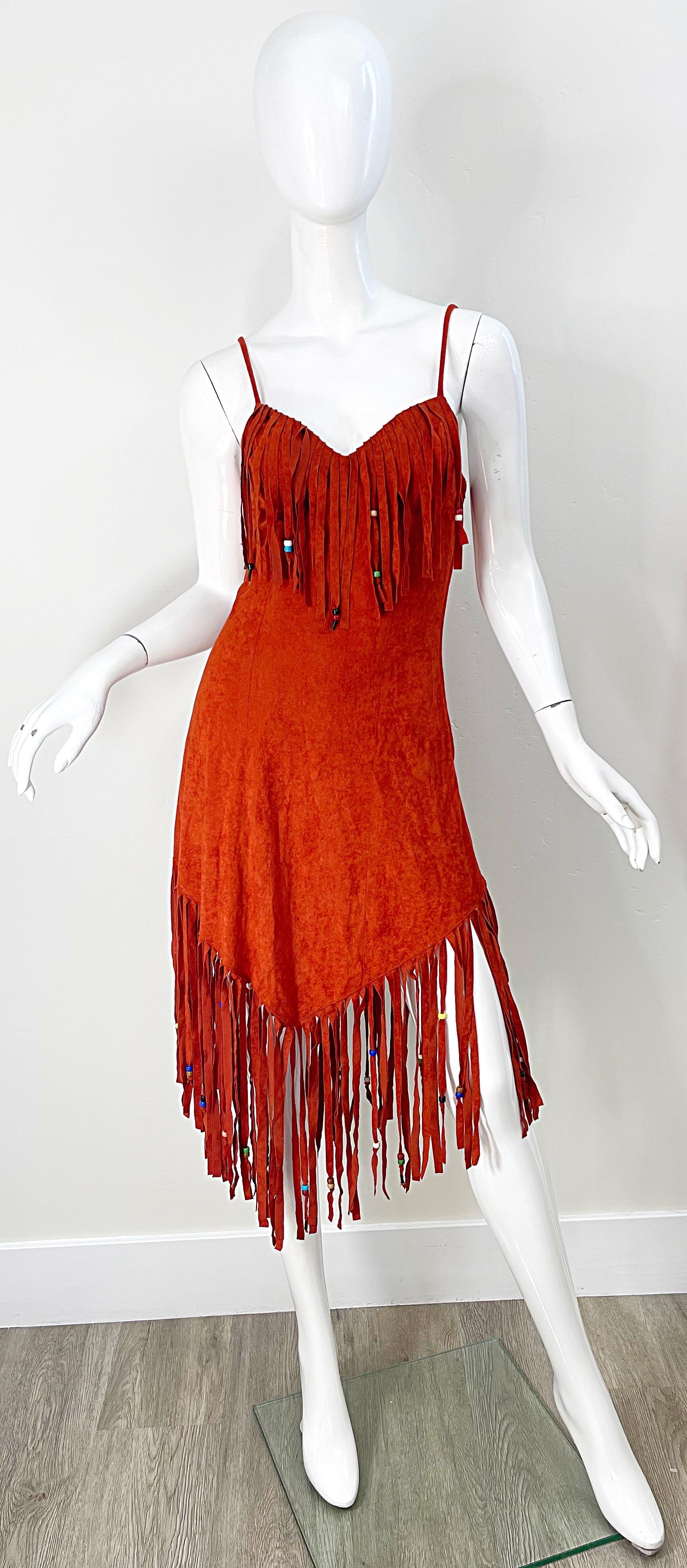 Amazing 1970s SAMIR rust colored faux suede spaghetti strap handkerchief hem boho beaded dress ! Features a soft faux suede with fringe at the neck and hem. Hidden zipper up the side. 
In great condition
Made in USA
Approximately Size Small -