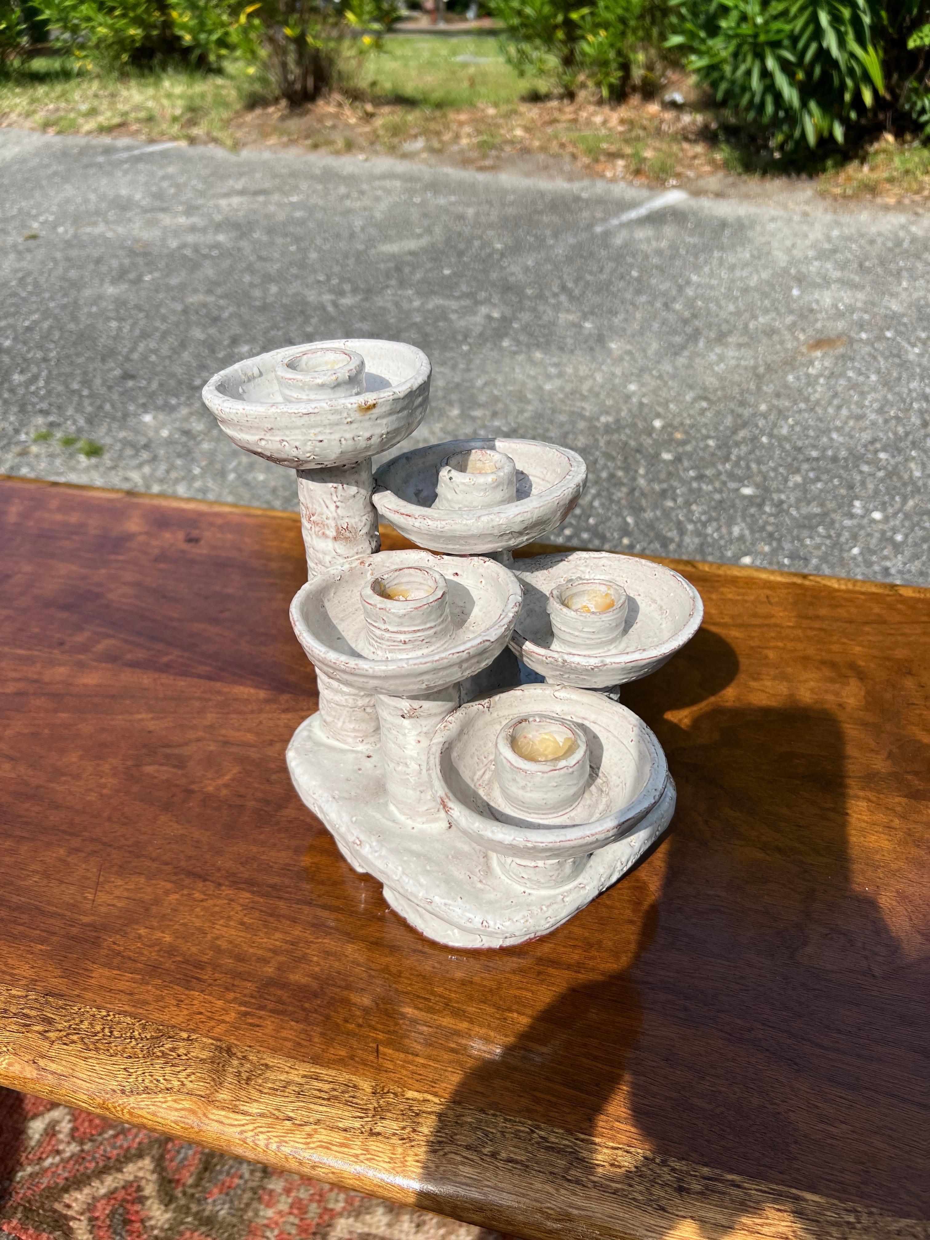 This is a rare mid-century 5 arm Candlebra.  By listed artist Mary Grabill.  Terra-cotta with a white glaze.   

About the artist:  In the mid-40's Mary turned the family's backyard chicken coup into a pottery studio called Graylor, where she