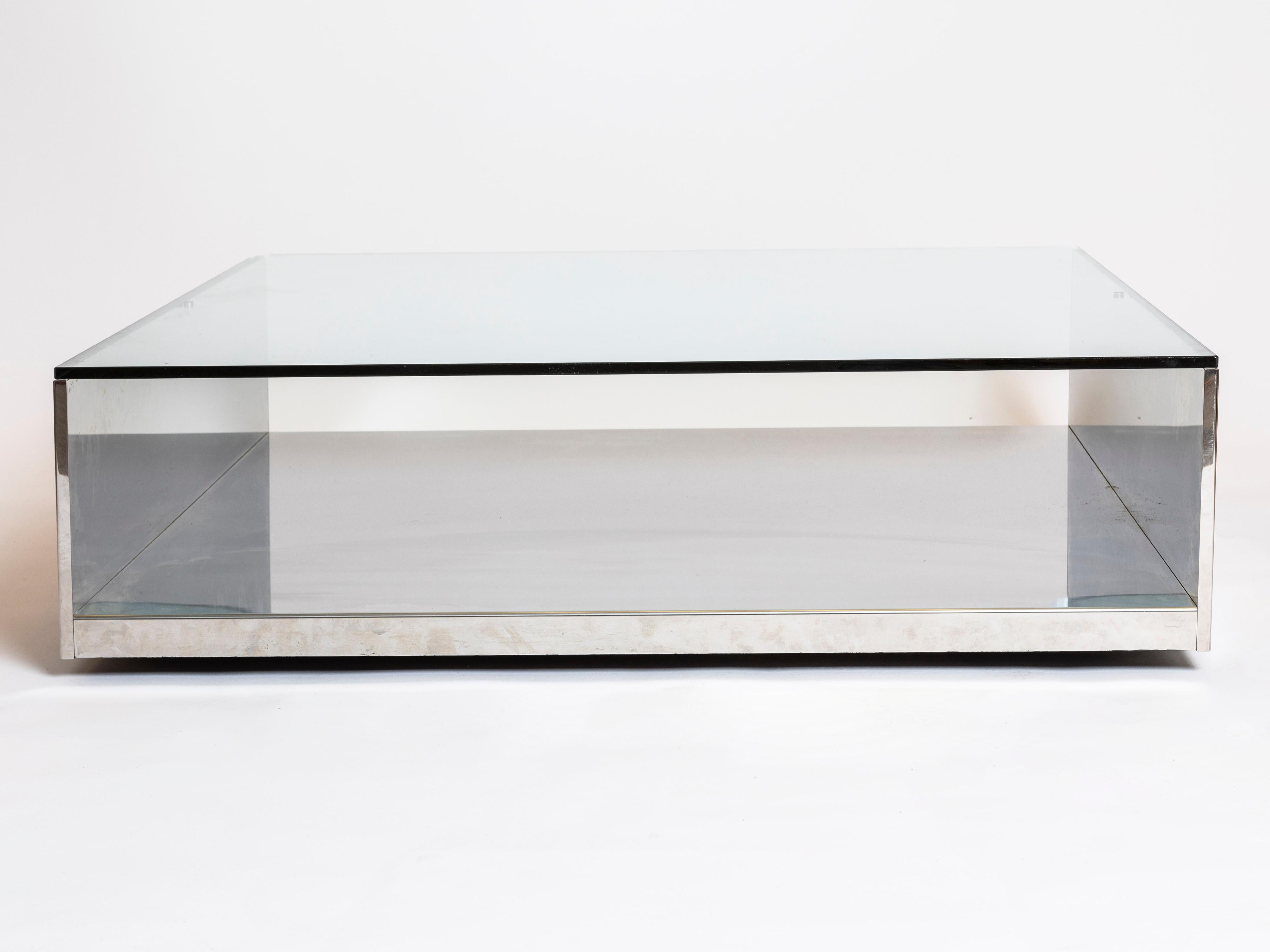 Embossed chrome coffee table with glass top, attributed to Saporiti Italia, 1970s. The main structure is done in wood embossed in metal and a thick glass top sits scarcely on the metal frame. There is one chipped corner of the glass top which is
