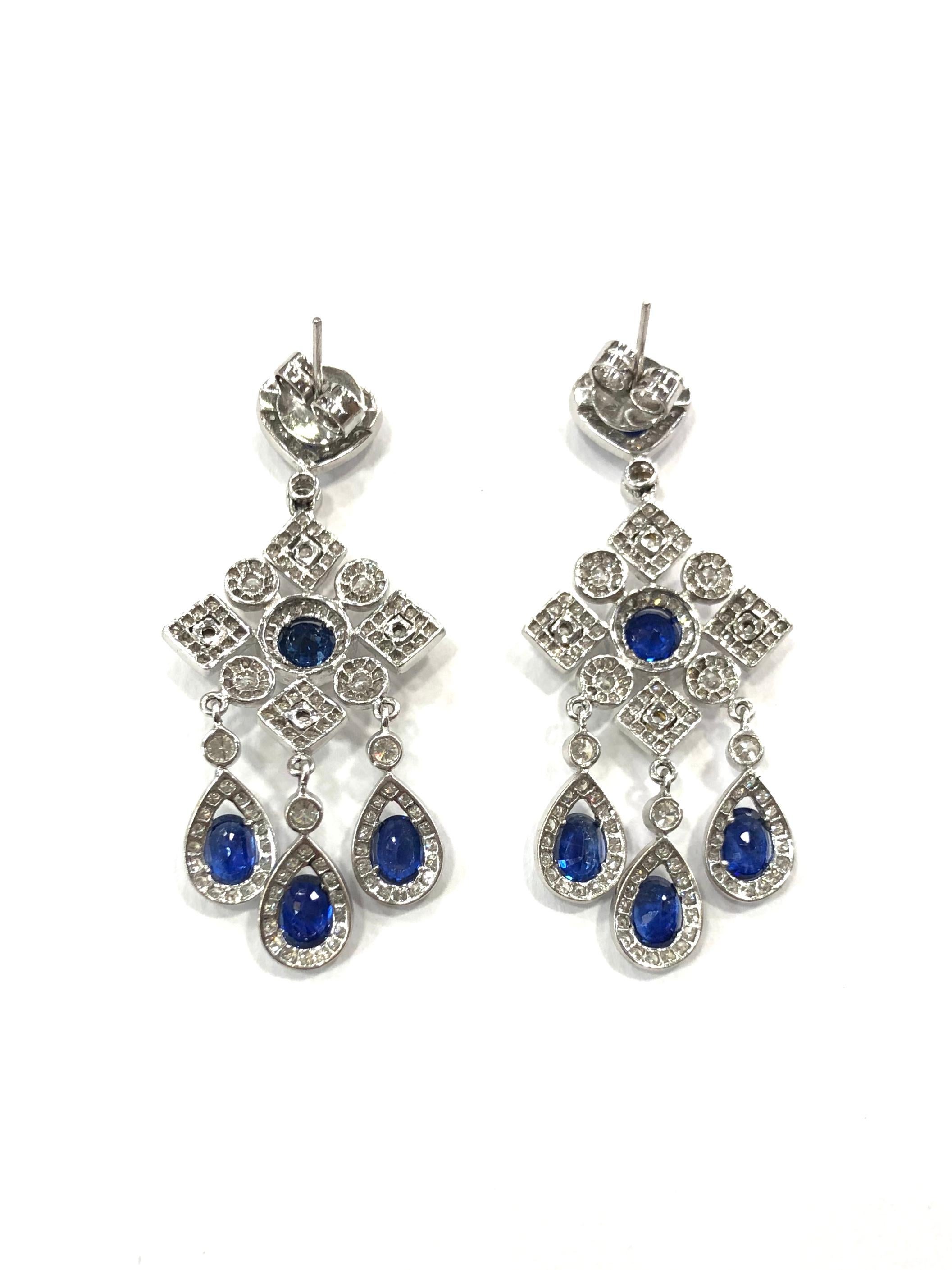 Beautiful pair of articulated Sapphire and Diamond drop Earrings. Made in the 1970s. 
Set in 18ct white gold.
With post and butterfly fittings
Pear shape, round and triangular Sapphires surrounded by round brilliant cut diamonds.

Approximate total