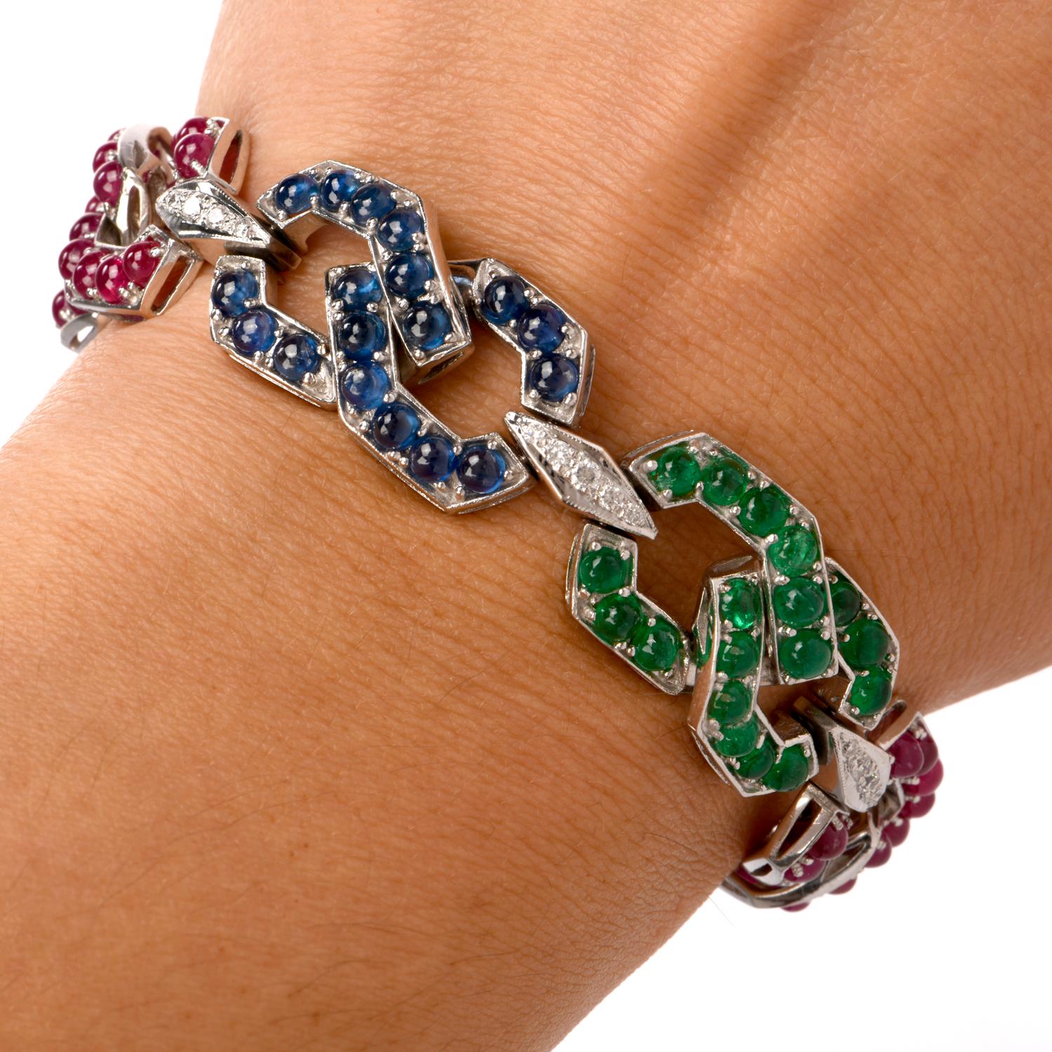 This vividly colored vintage link bracelet with sapphire, emerald and ruby cabochons and pave diamonds is crafted in 18 karat white gold, weighs 43.9 grams and measures 6.75 inches long and 15 mm wide. The bracelet is composed of 12 interlocking