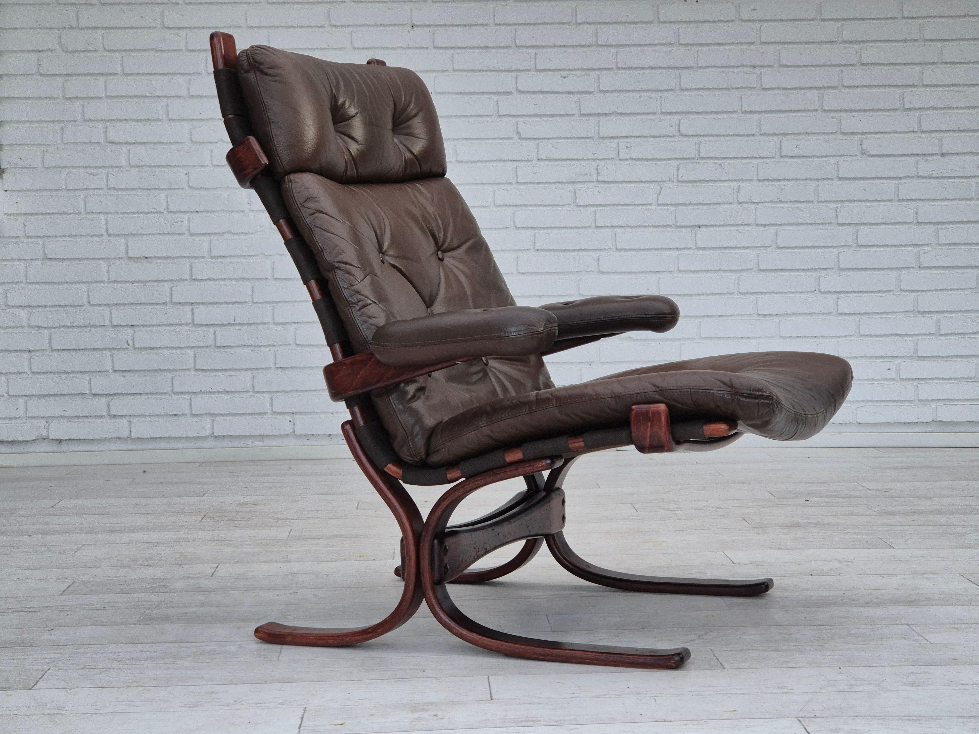 1970s, Scandinavian armchair. Original very good condition: no smells, no stains, and stable construction. Original brown furniture leather, bent wood, canvas. Manufactured by Danish or Swedish furniture maker in about 1970-75s. Original