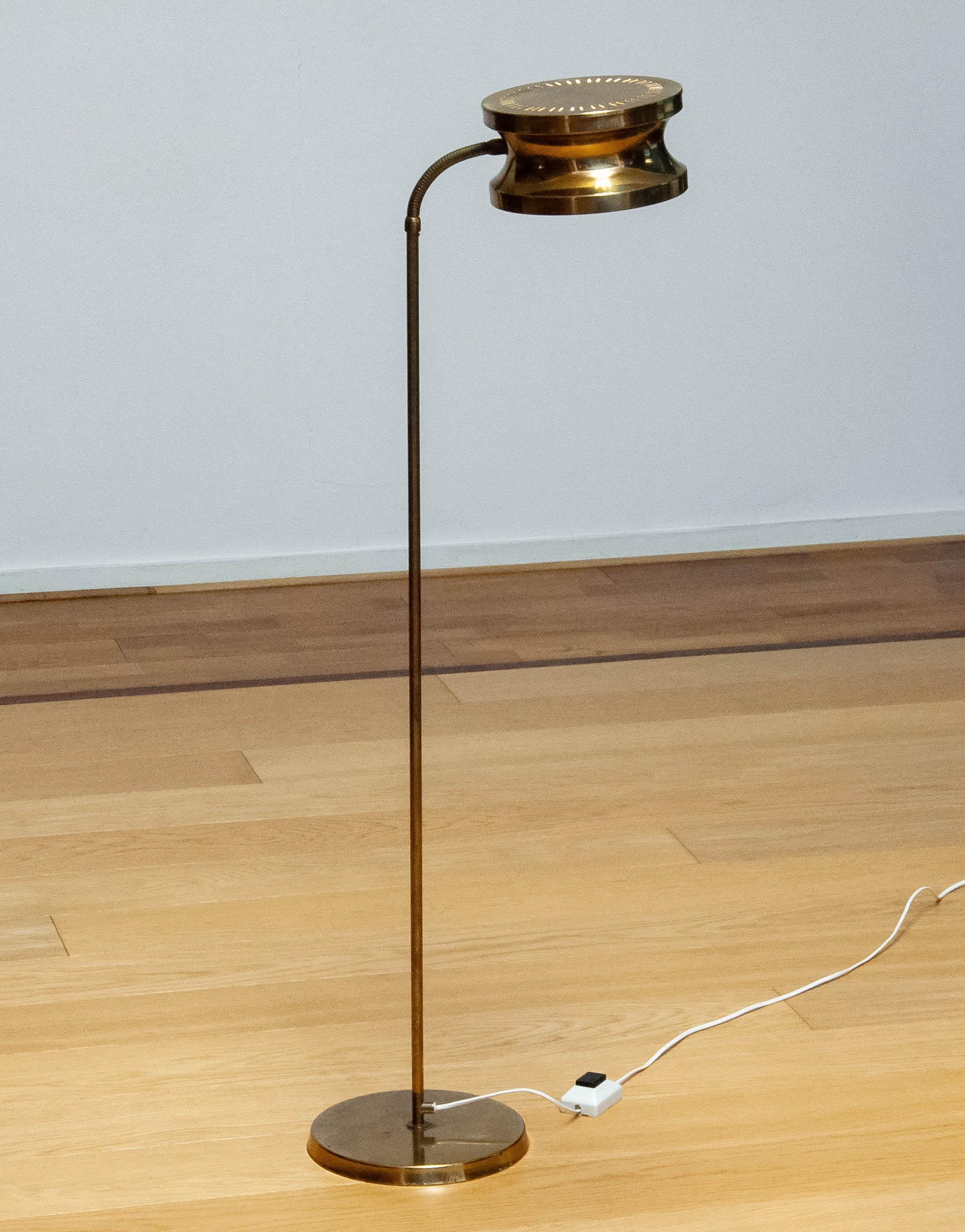 Beautiful Scandinavian Modern floor lamp in polished brass made in Sweden in the 1970s by Tyringe Konsthantverk which suits in many interiors. Once switched on the perforated lamp shade gives this floor lamp her characteristic appearance which is a