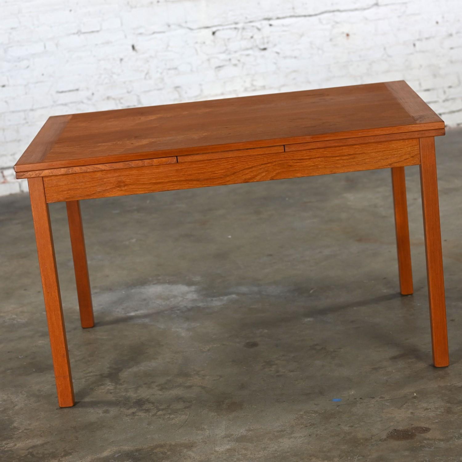 Marvelous vintage Scandinavian Modern D Scan teak draw leaf expanding dining table. Beautiful condition, keeping in mind that this is vintage and not new so will have signs of use and wear even if it has been refinished or restored. Specifically,