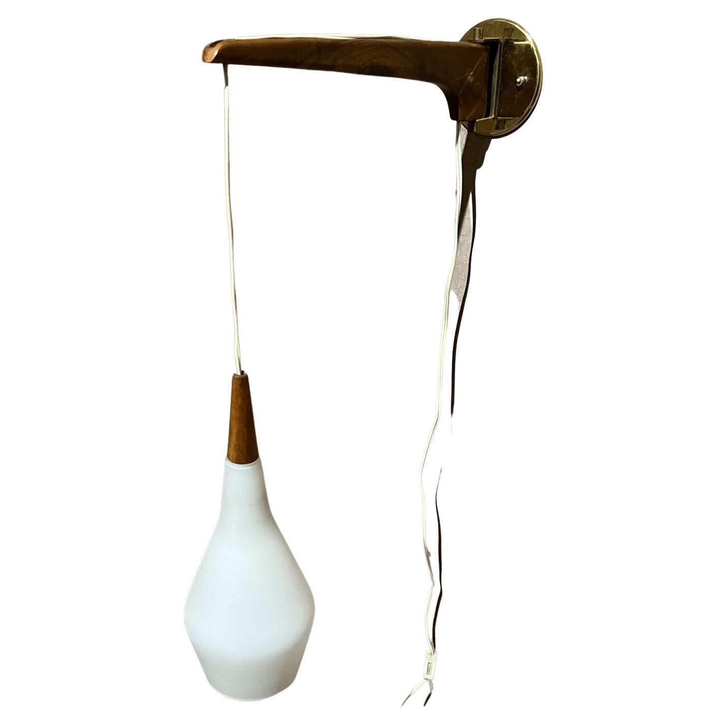 1970s Scandinavian Modern Wall Sconce Swag Pendant Teakwood Frosted Glass
Unmarked, in the style of Finnish designer Lisa Johansson-Pape.
Adjustable height and swiveling angle.
16 d x4 w shade h 13 adjustable
Preowned original vintage condition.
See