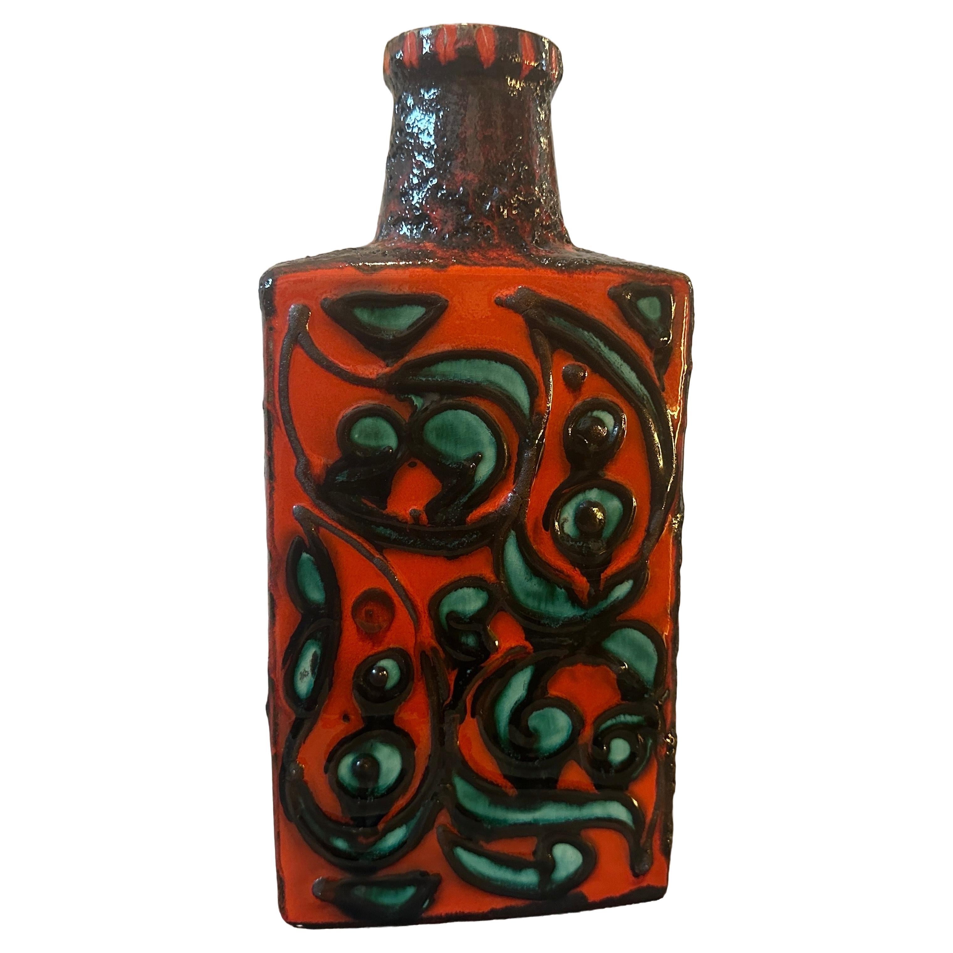 A fat lava ceramic bottle vase designed and manufactured in West Germany in the Seventies by Scheurich, 
This bottle Vase is a striking and iconic piece of ceramic art that captures the essence of the Fat Lava style, a popular trend in West German