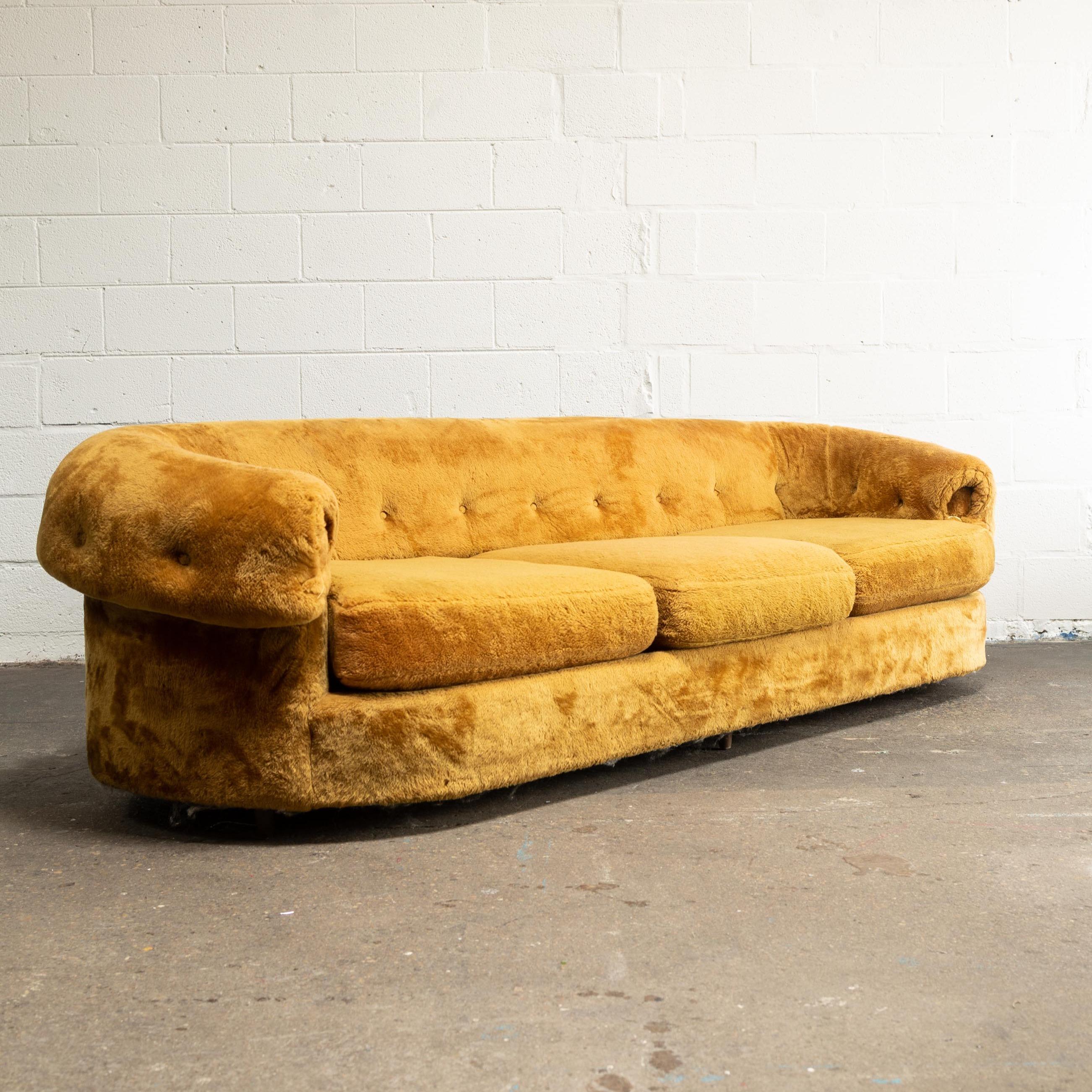 This plush sofa features it's original fabric in excellent condition and arm covers unopened in their original packaging. It has been rarely used and is incredibly comfortable.