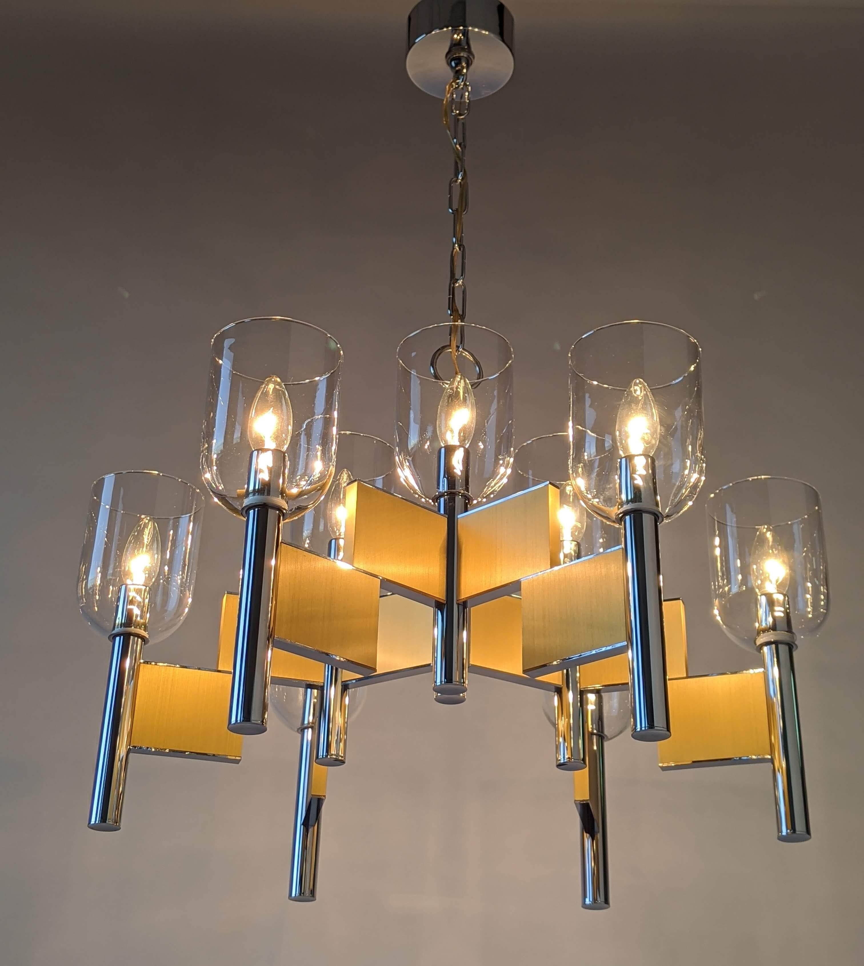 Mouth blowed glass hurricane chandelier made of thick chromed steel and brass. 

Prime quality material, solid construction.

Chandelier measure 25 in. wide by 19 in. high.

Chain length with canopy 16 in. high. Could be adjusted.

9 E12 candelabra