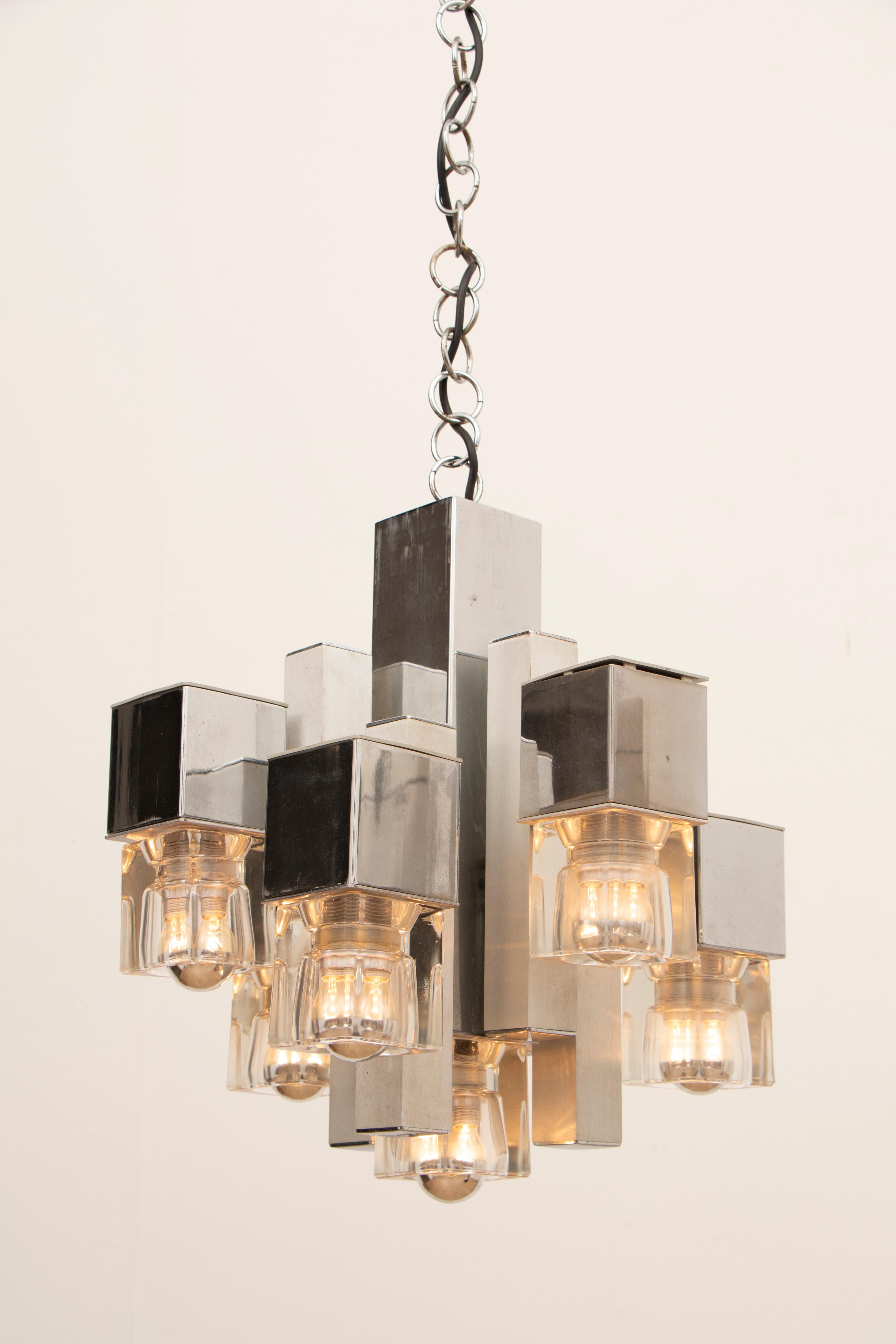 1970s Italian abstract cubic ceiling hanging light designed by Gaetano Sciolari. The staggered cubic shapes which are made of chromed metal and aluminium with heavy glass cubes at the end of each one. A screw-in E14 bulb is required within each