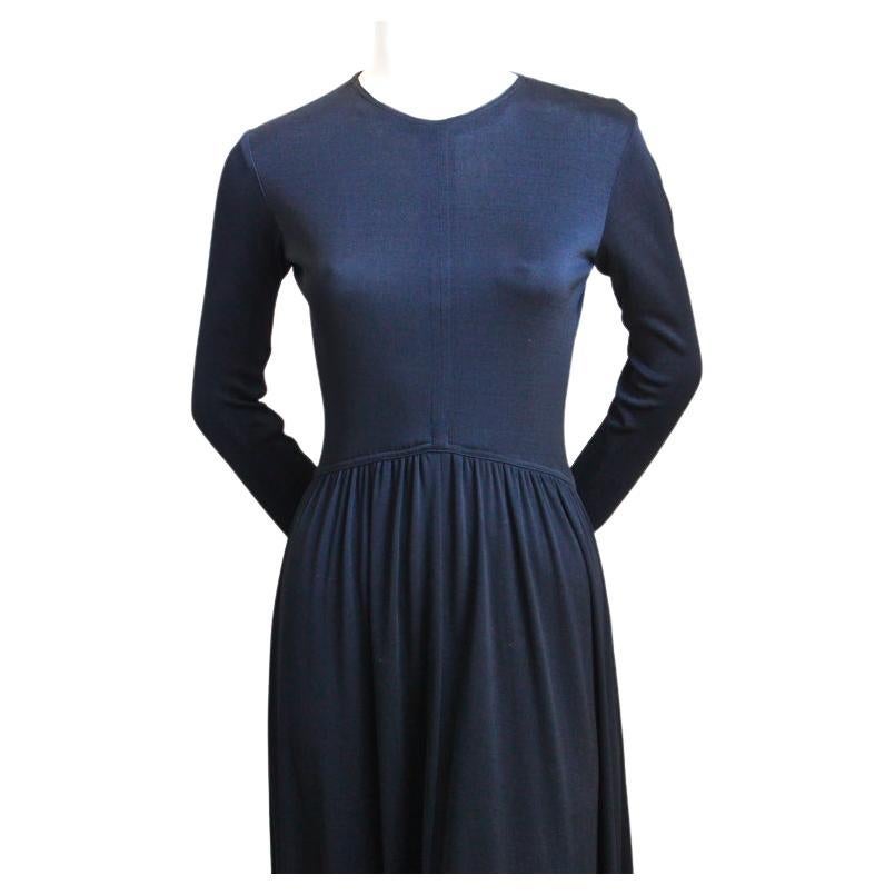 Jet-black, jersey dress designed by Scott Barrie dating to the 1970's. Dress fits a size 4. Dress measures approximately 32