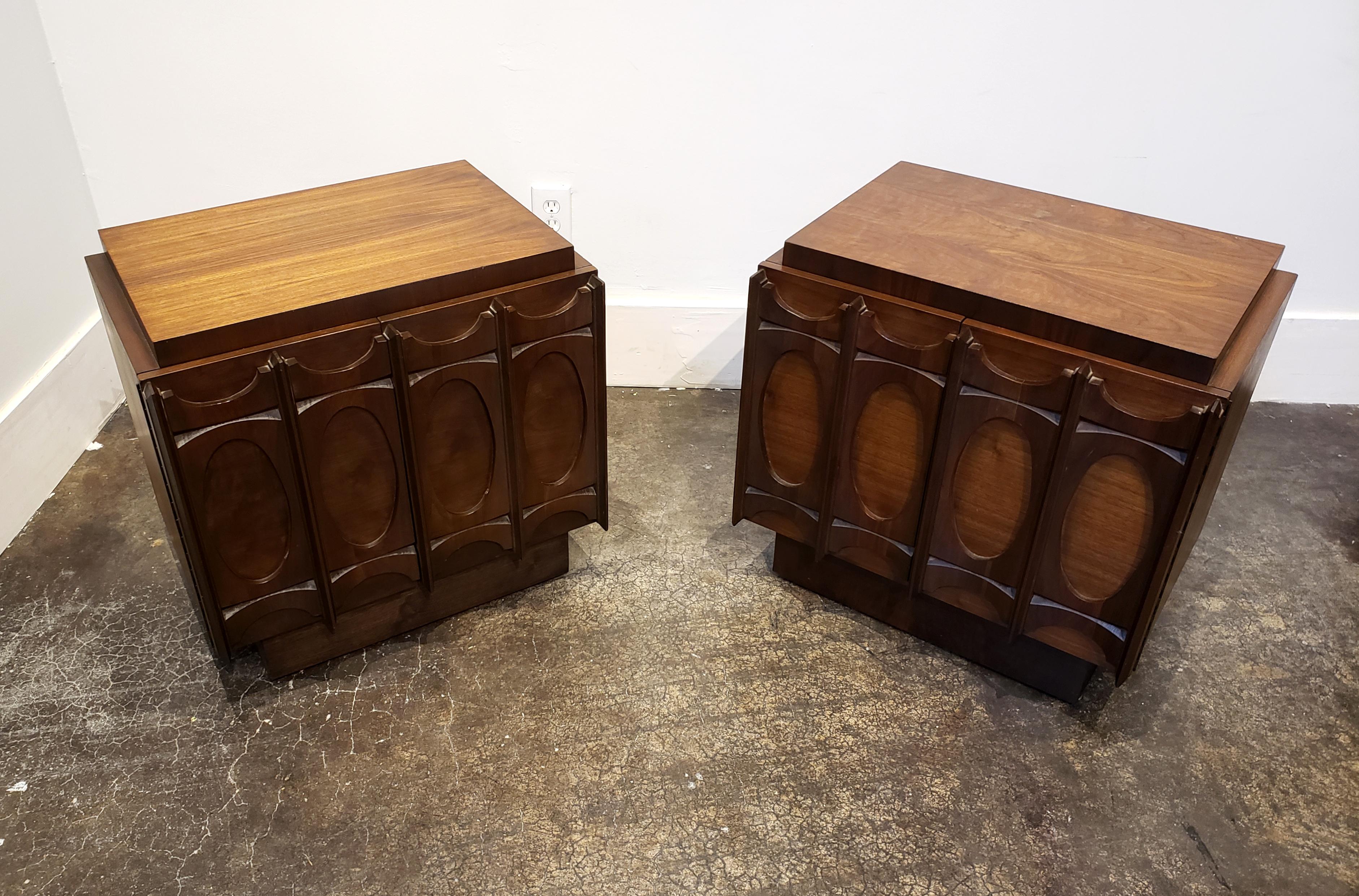 Brutalist 1970s walnut wood nightstands with strong sculptural, Brasilia-style front. Would be a stunning addition to any setting, traditional or modern. 

     