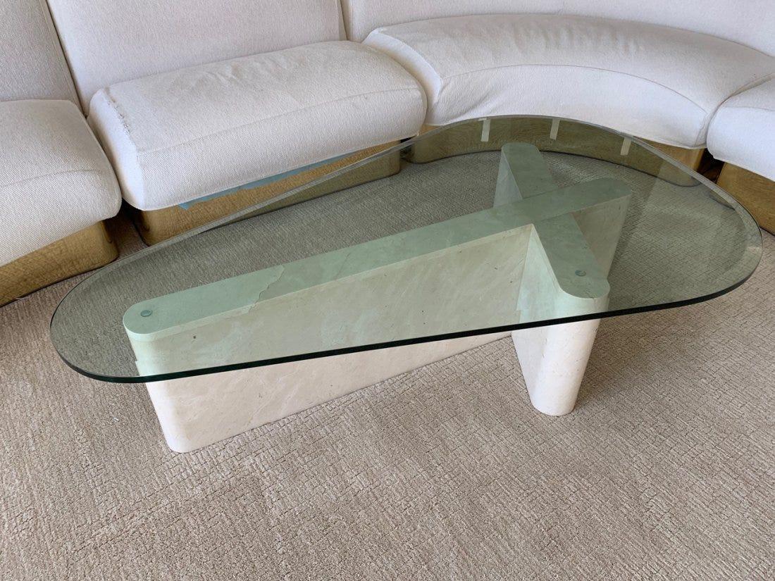 Sculptural coffee table made in the early 1970s and executed in travertine with a beveled glass top. The table has rounded ends and the glass is in a tear shape to follow the shape of the travertine base.
Measurements:
60.75 inches wide x 36.75