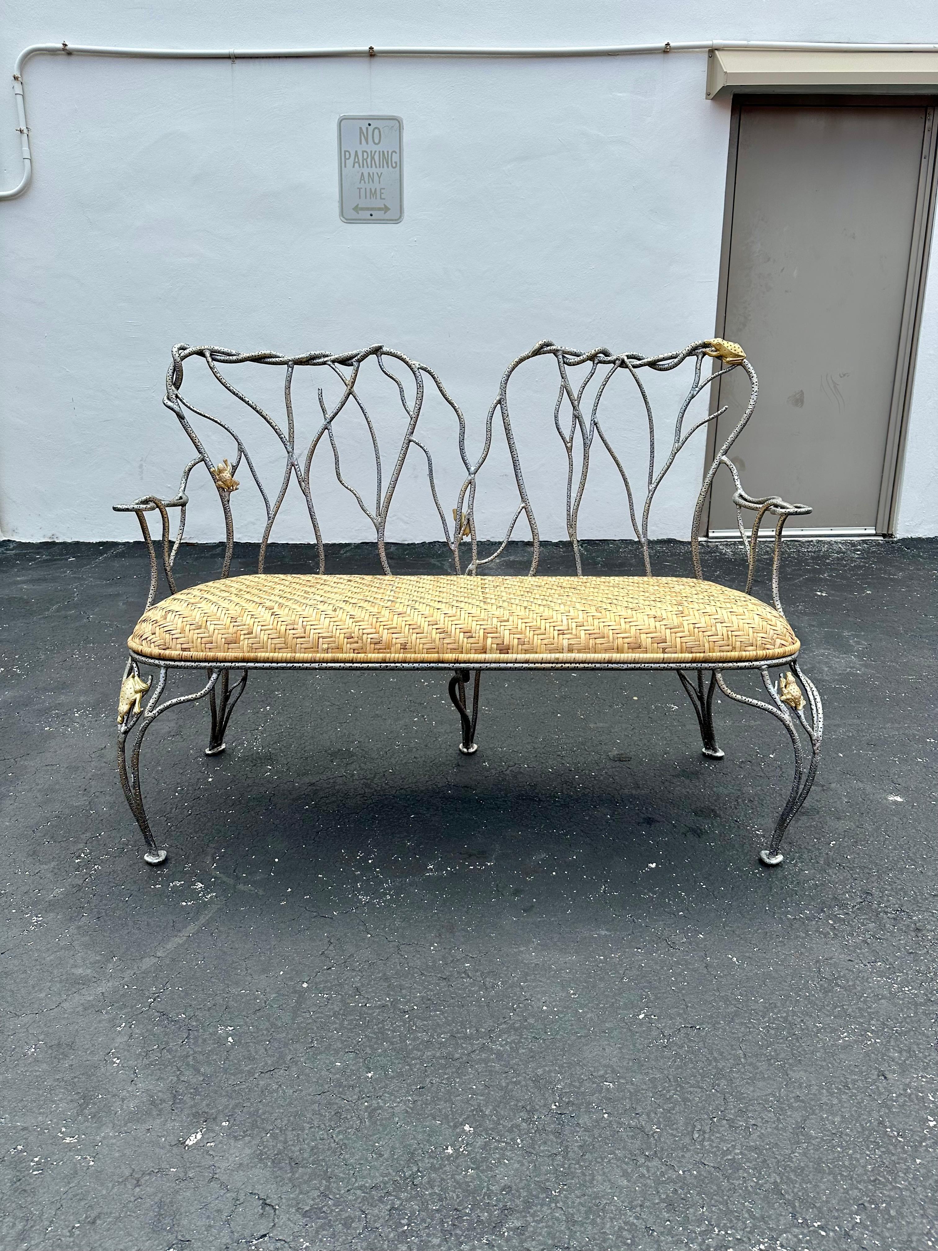 On offer on this occasion is one of the most stunning and rare, sculptural wrought iron and rattan settee bench you could hope to find. In its original condition. No restoration. Outstanding design is exhibited throughout. The settee is statement