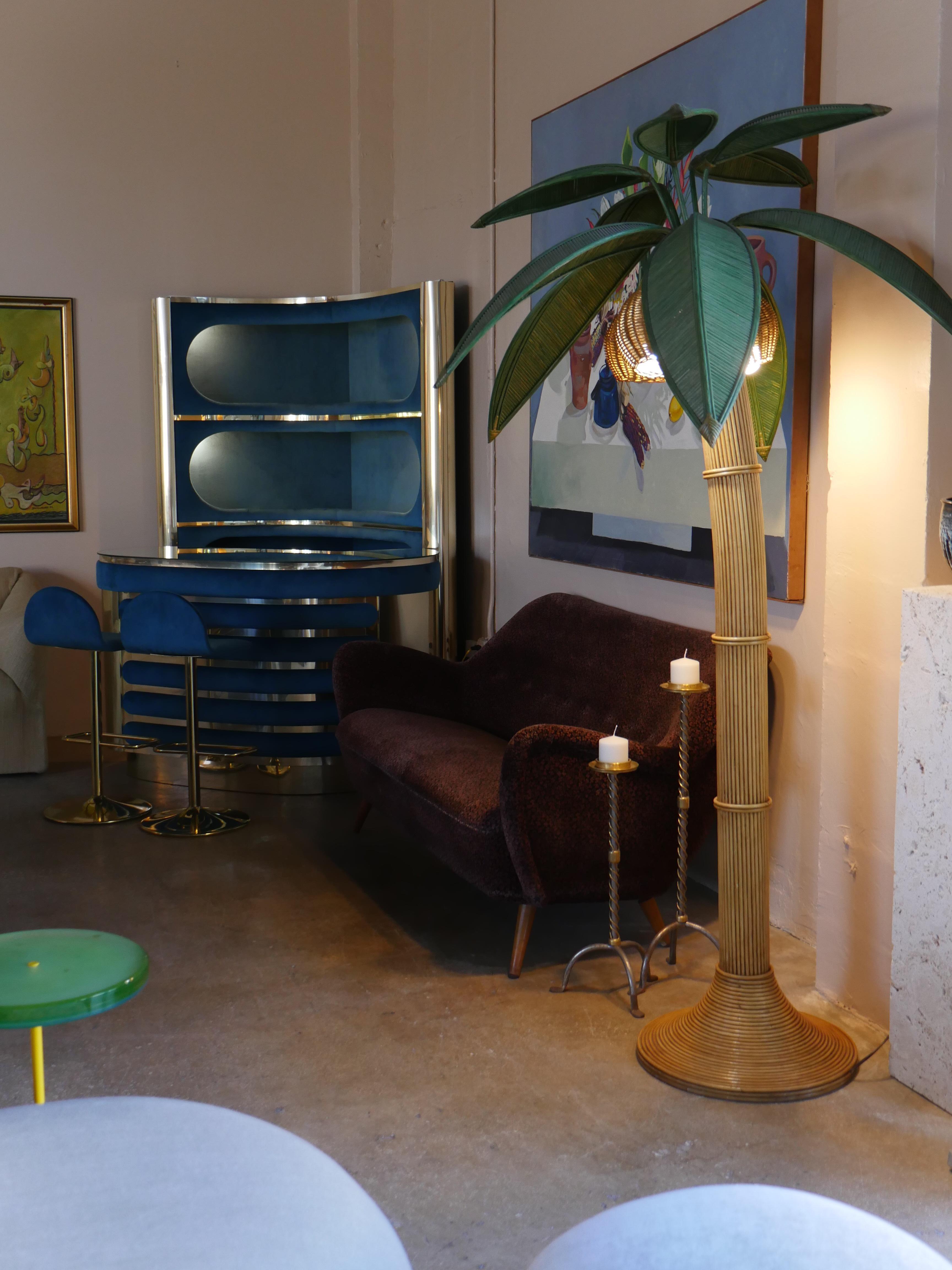  Bring warmth, texture, and a touch of charm to your space with this stunning sculptural, vintage rattan floor lamp from the 1970s. Its unique, artful design adds both fun and sophistication, making it a perfect statement piece for any room.