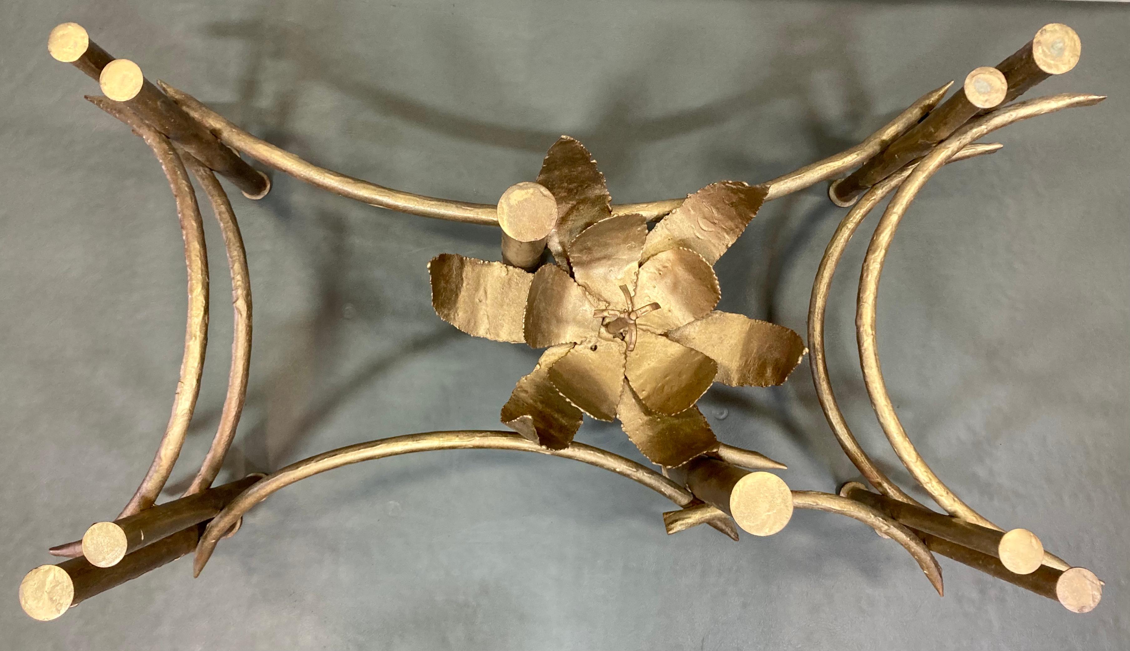 Stunning coffee table base depicting a lotus blossom with sculptural elements, finished in gold. Made of a combination of steelworking techniques in the Hollywood Regency style. Frame is sold without glass top. 

Dimensions: 35