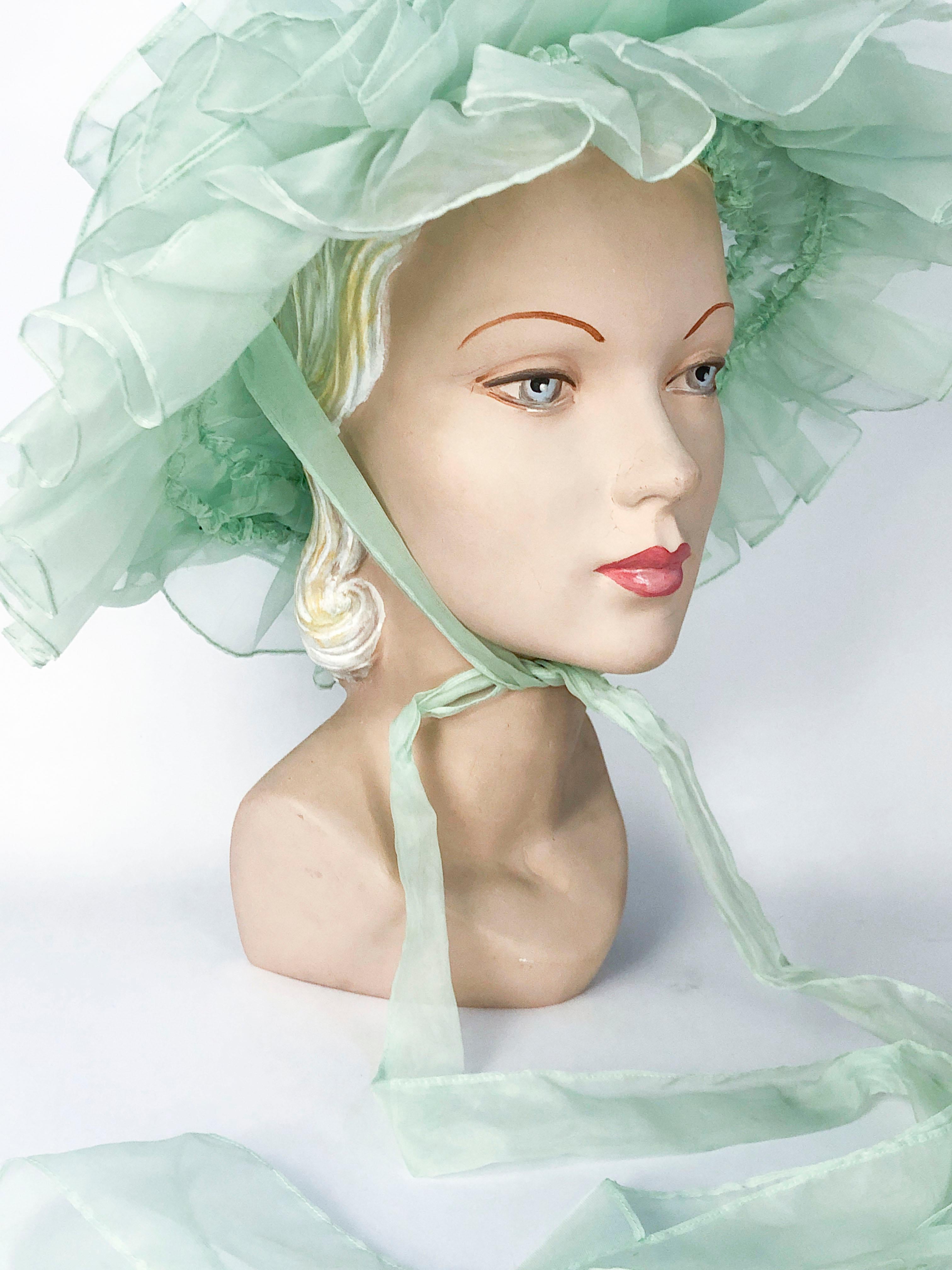 1970's Sea Foam Green Fashion Hat with Layered Ruffles and tie that creates a large bow. The ruffles are all hand ruched and applied to a wire frame.