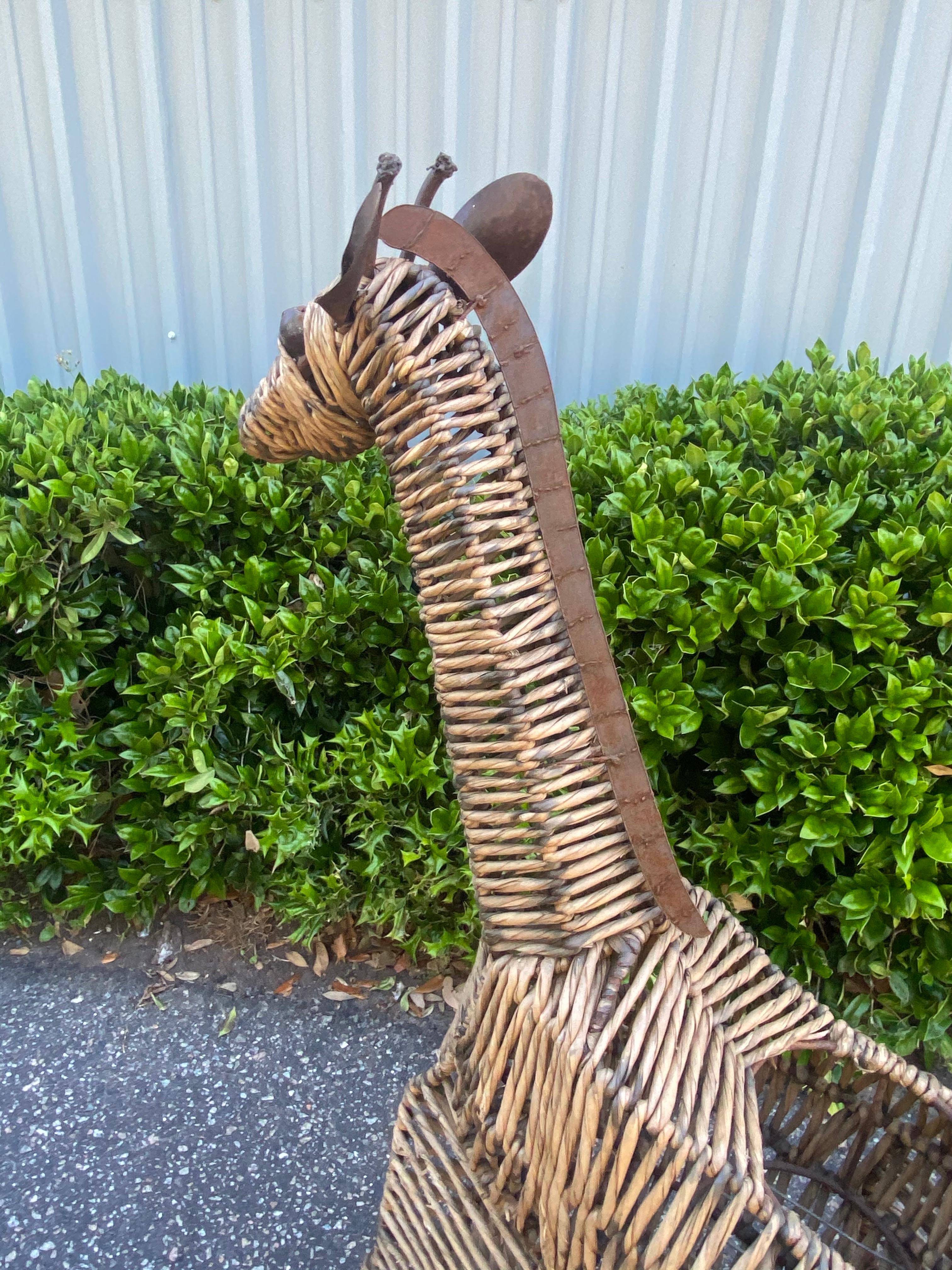Vintage Large Scale Mid-Century Wire and Woven Sea Grass Giraffe Planter of pot holder. This fella is super sturdy with a steel frame, steel accents like his mane, ears and facial features. The frame is covered in woven sea grass that was built to