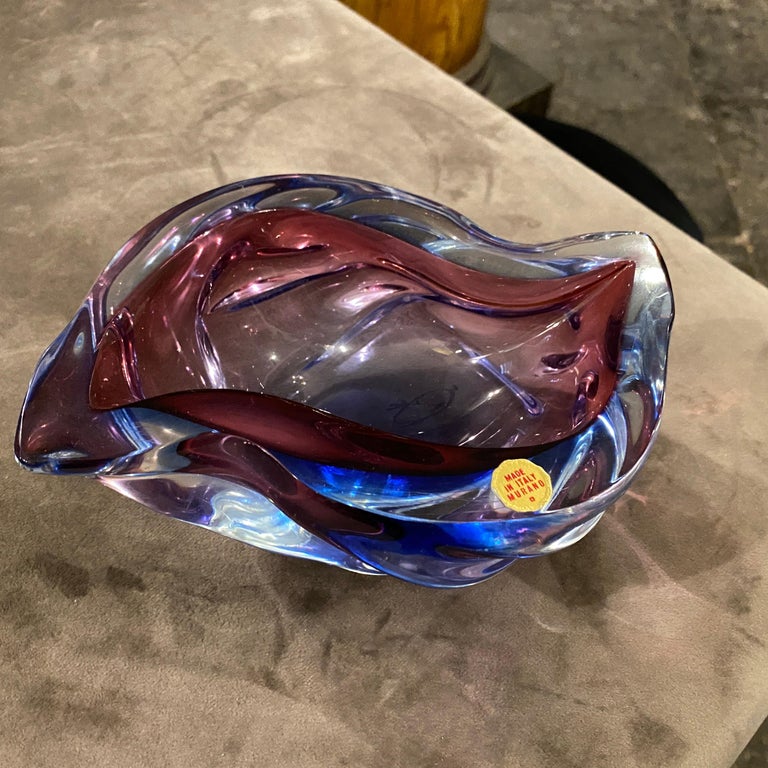 A stylish hand-crafted sommerso murano glass ashtray, the purple and blue glass it's in perfect conditions, it has been designed and hand-crafted in Venice in the Seventies in the manner of Seguso world famous manufacturer, it has an original label