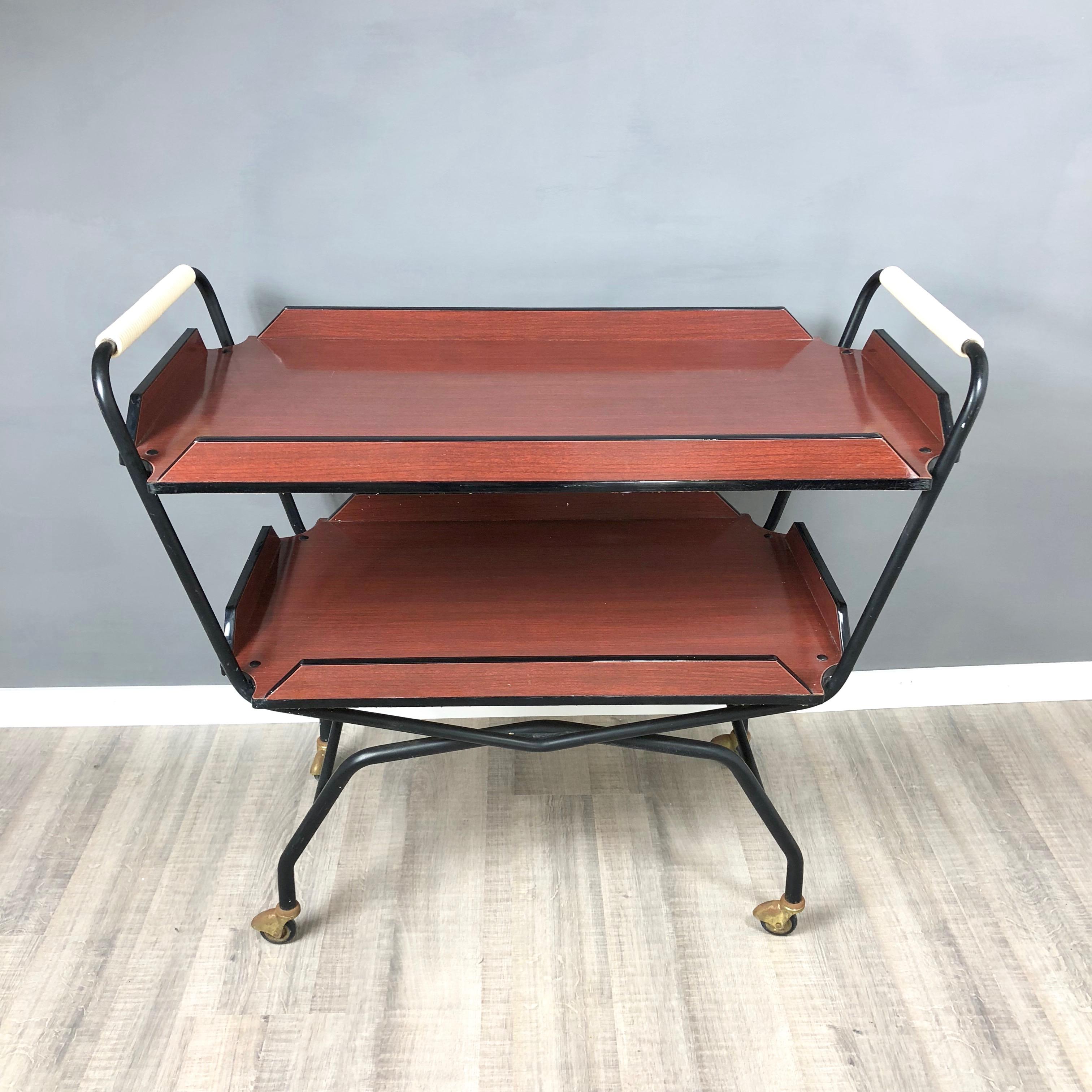 Black and red brown serving bar cart or trolley in formica and metal with double tray.