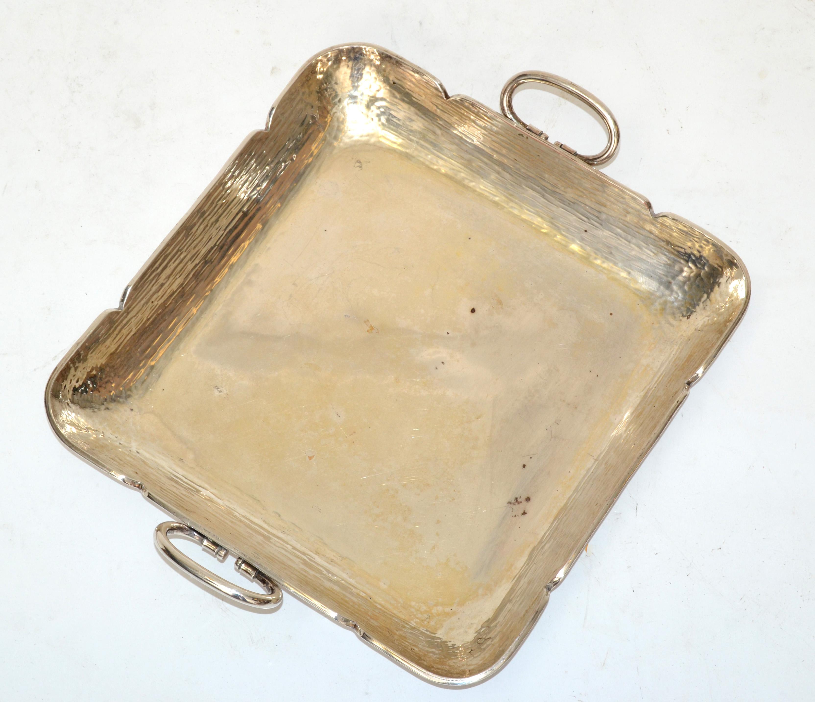Square decorative serving tray made out of hammered cutout steel and silver plate handles.
Mid-Century Modern Design made in America in the early 1970s.
In pristine vintage condition with some spotting to the Metal & tarnish to the Silver Plate.