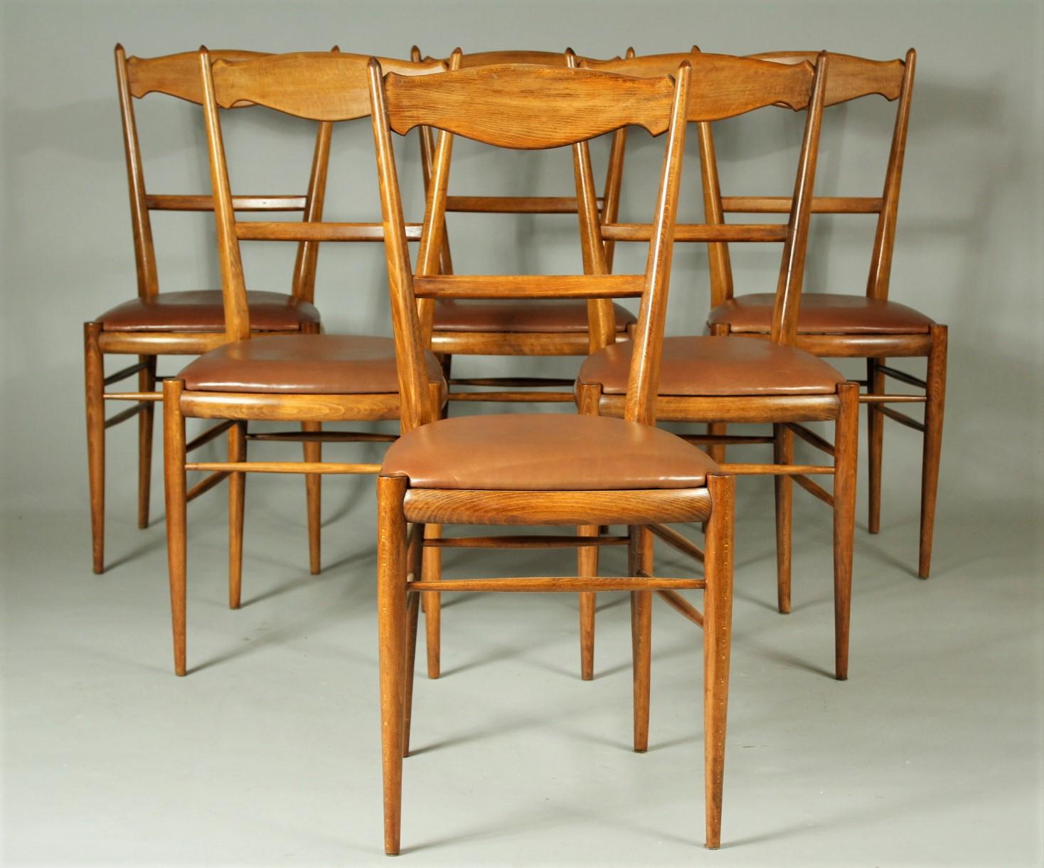 Set of six beech dining chairs from the 1970s. They are upholstered in natural cow leather. These chairs are in very good condition, they have been restored.