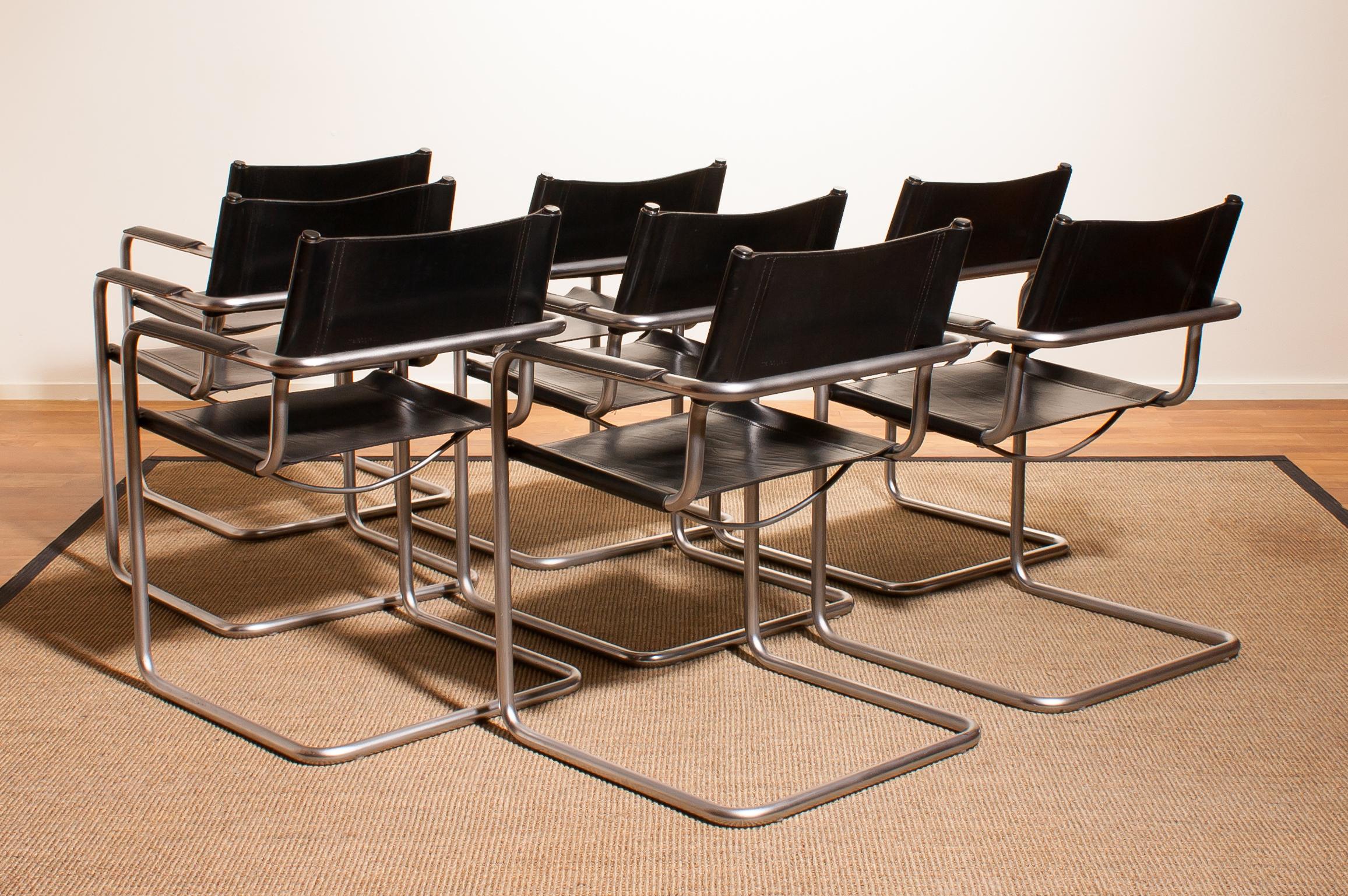 A beautiful set of eight dining chairs made by Matteo Grassi, Italy.
The chairs have tubular titanium look steel frames with sturdy black leather seating and back and armrest.
They are signed on the back of the backrest.
The chairs are in a very