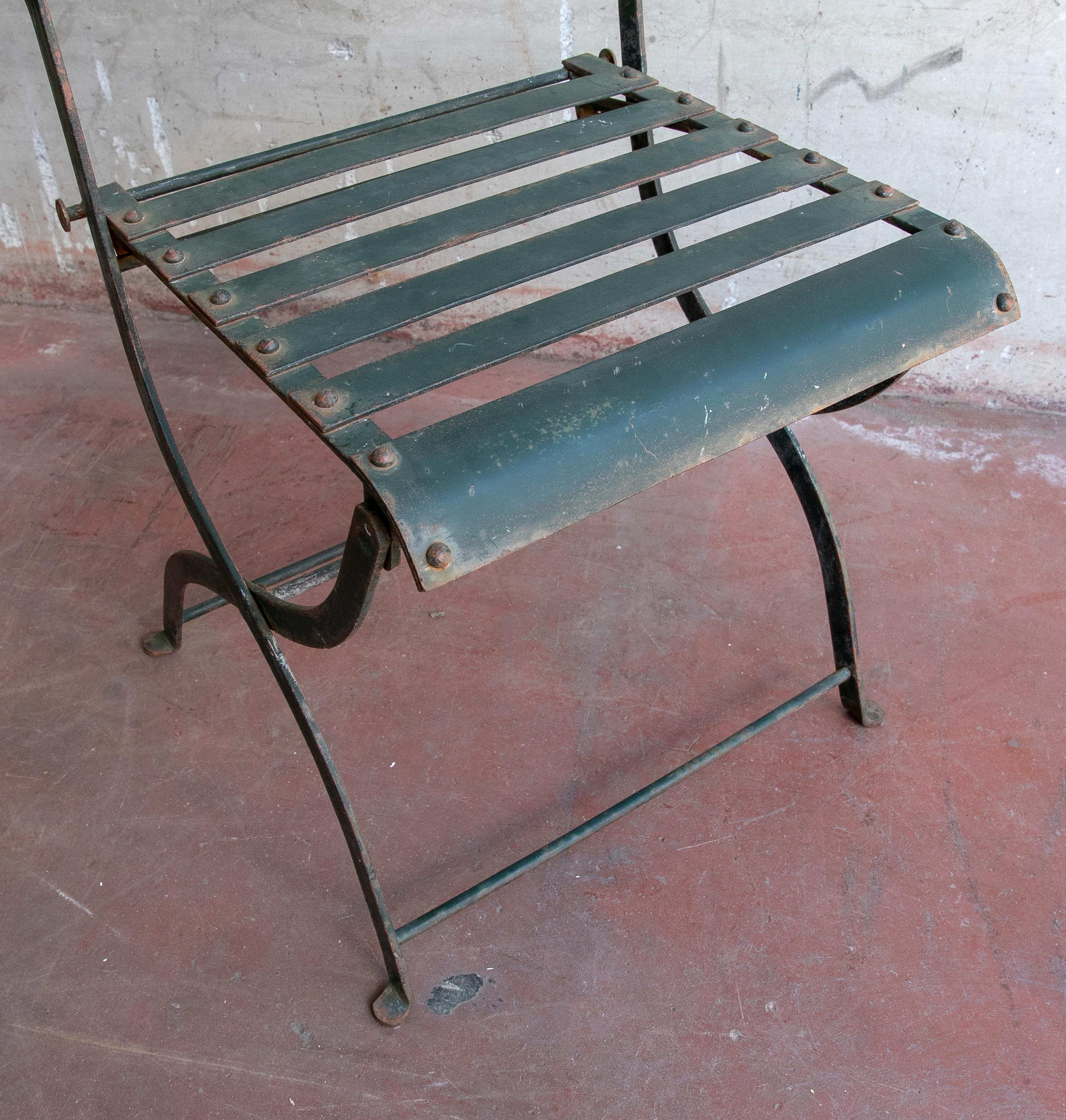 1970s set of four French iron chairs painted in green.