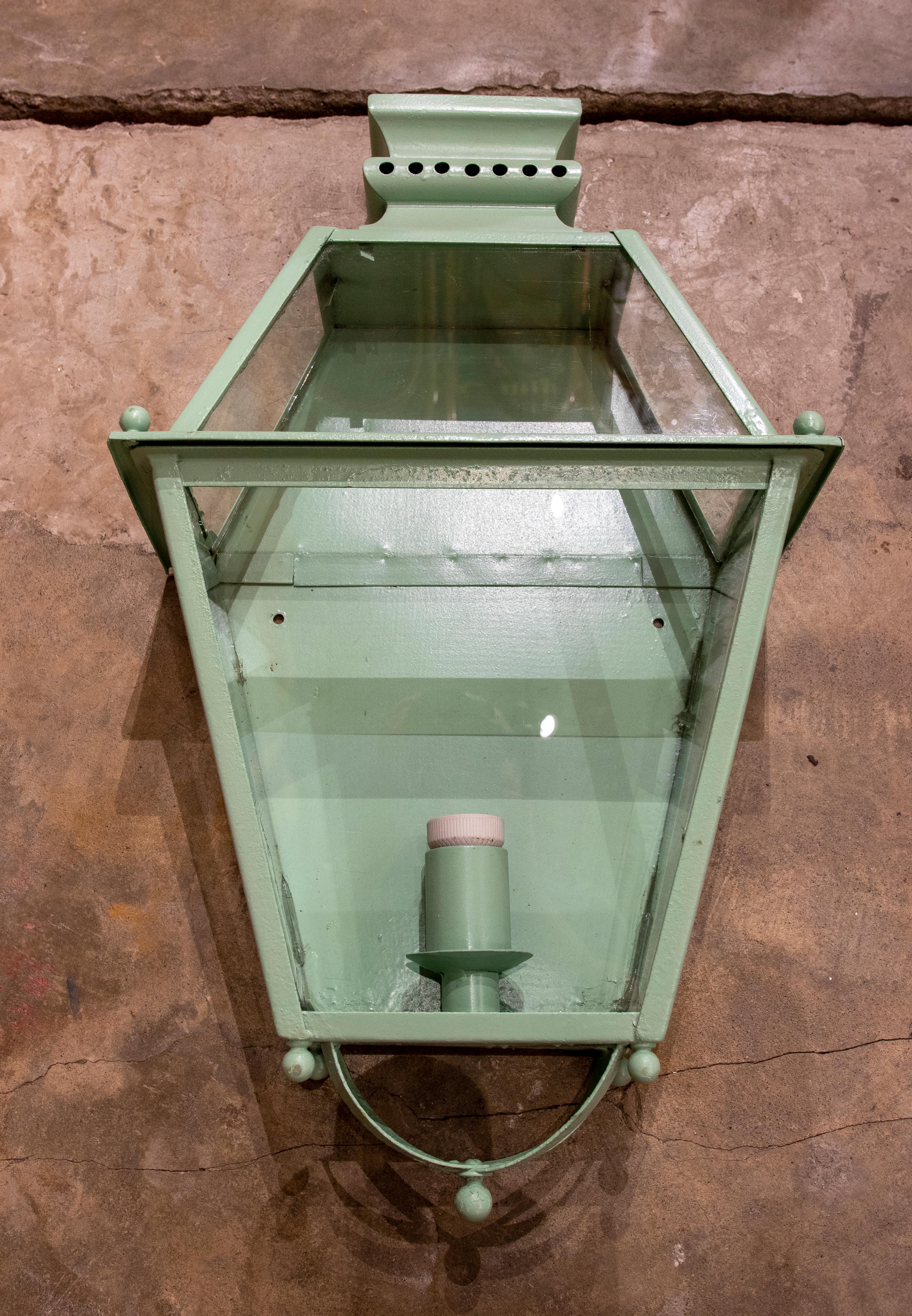 1970s Set of four green painted iron wall lanterns.