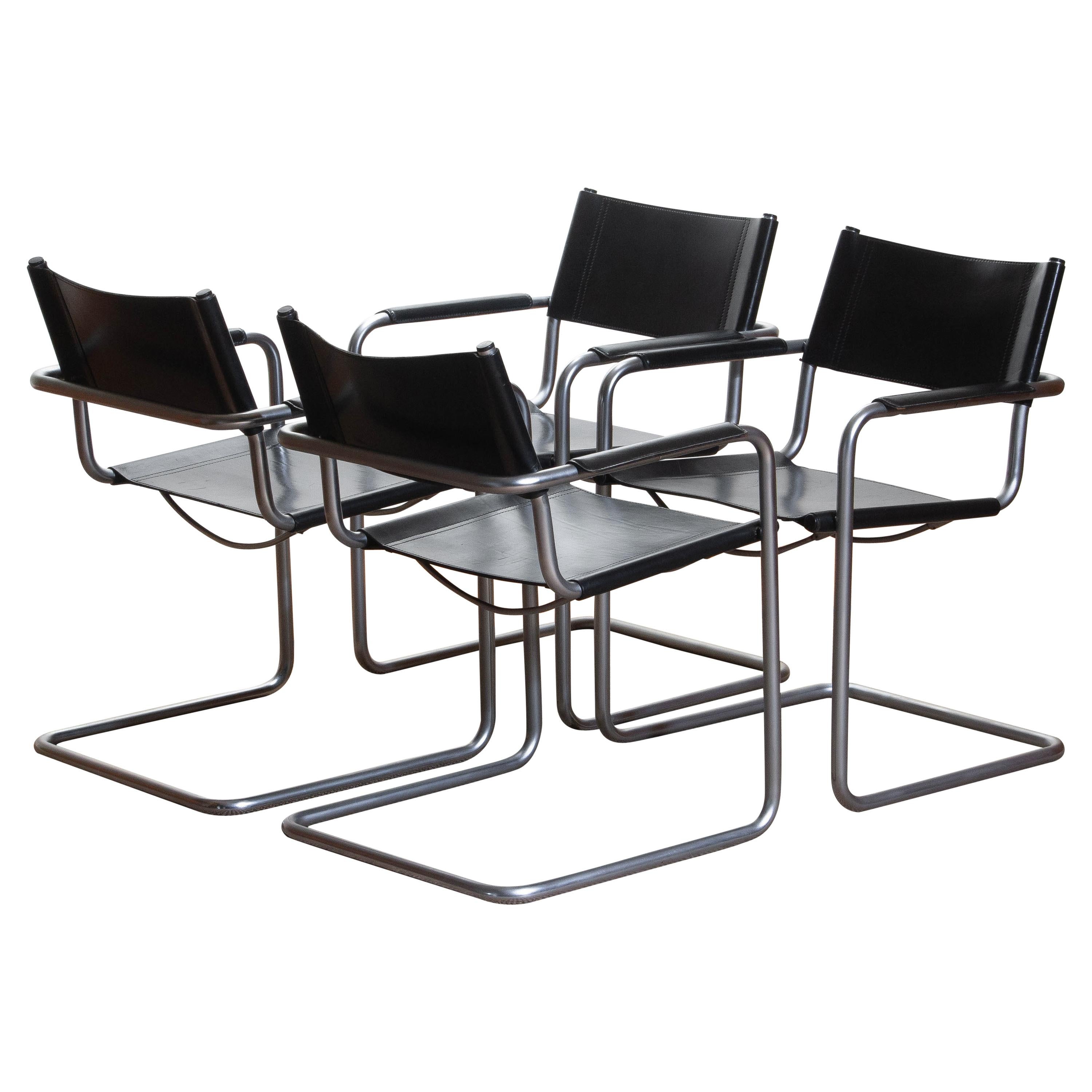 1970, perfect set of four dining / office chairs made by Matteo Grassi, Italy.
The chairs have tubular titanium look steel frames with sturdy black leather seating and backrest.
They are signed on the back of the backrest.
Overall condition is