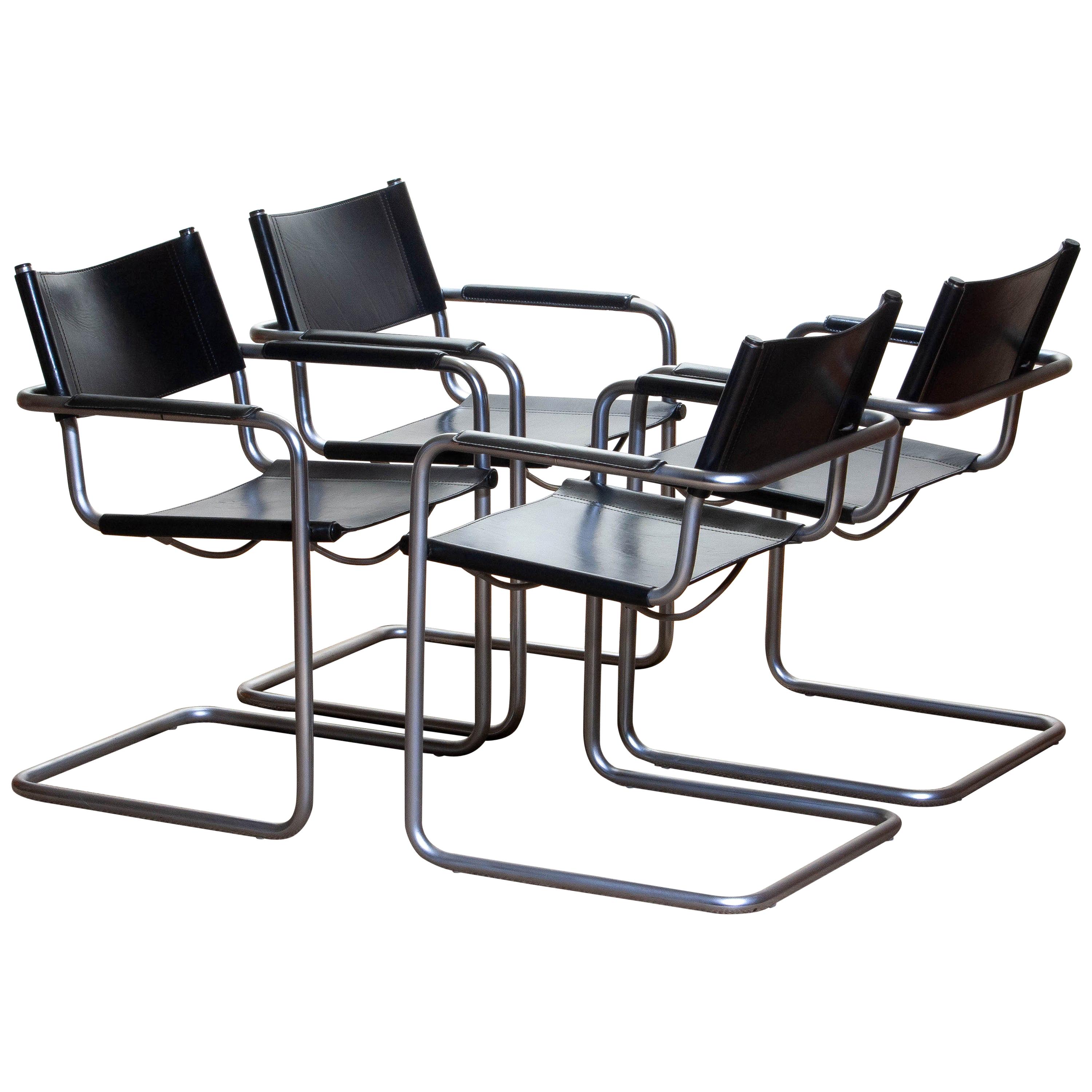 1970, perfect set of four dining / office chairs made by Matteo Grassi, Italy.
The chairs have tubular titanium look steel frames with sturdy black leather seating and backrest.
They are signed on the back of the backrest.
Overall condition is