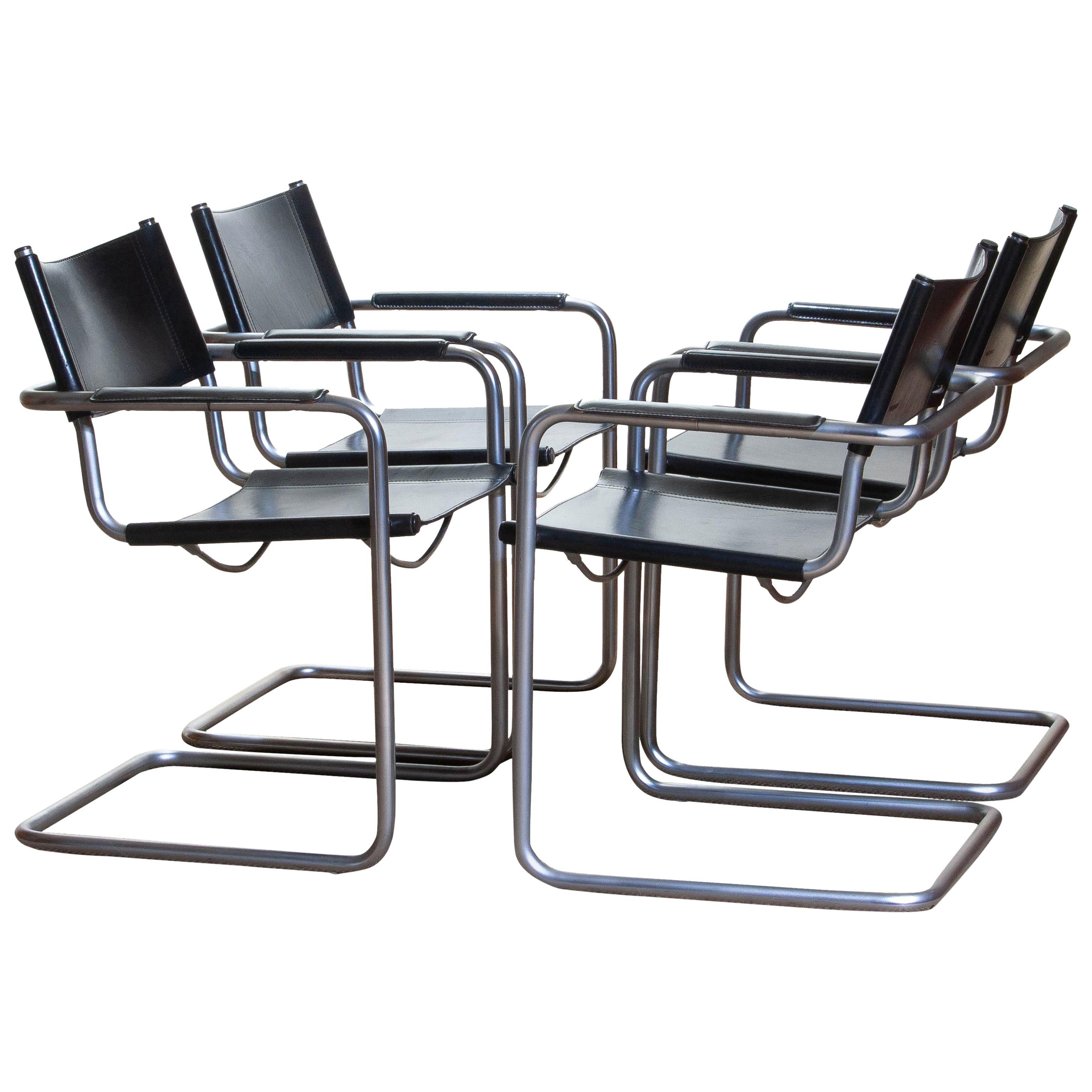 1970, perfect set of four dining or office chairs made by Matteo Grassi, Italy.
The chairs have tubular titanium look steel frames with sturdy black leather seating and backrest.
They are signed on the back of the backrest.
Overall condition is