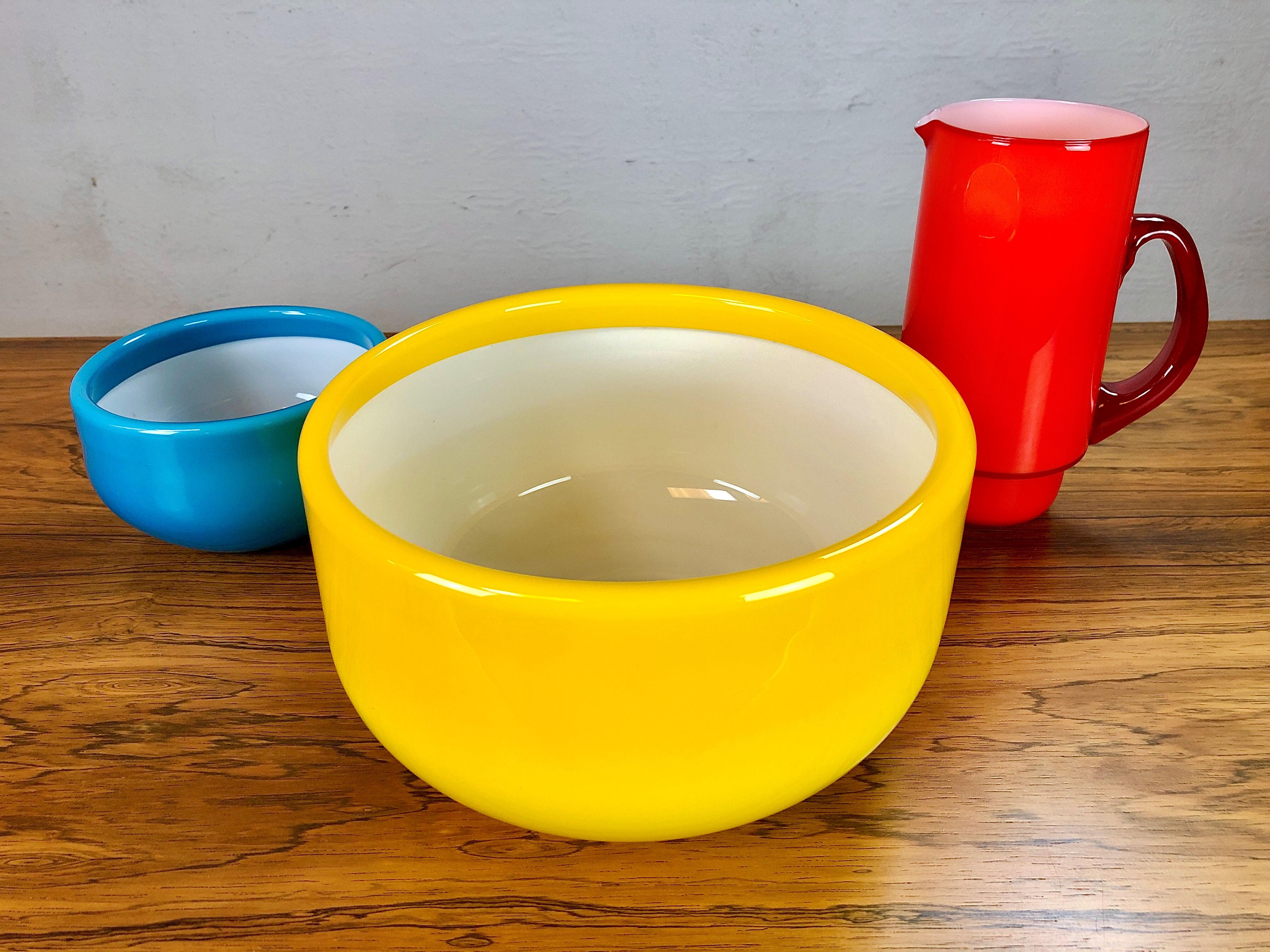 Set of pitcher and bowls in yellow, red and blue glass designed by Michael Bang and produced by Holmegaard in the 1970s.

The well designed set with it´s bright 1970´s colors in excellent condition.

Michael Bang (1942-2013) was the son of Jacob
