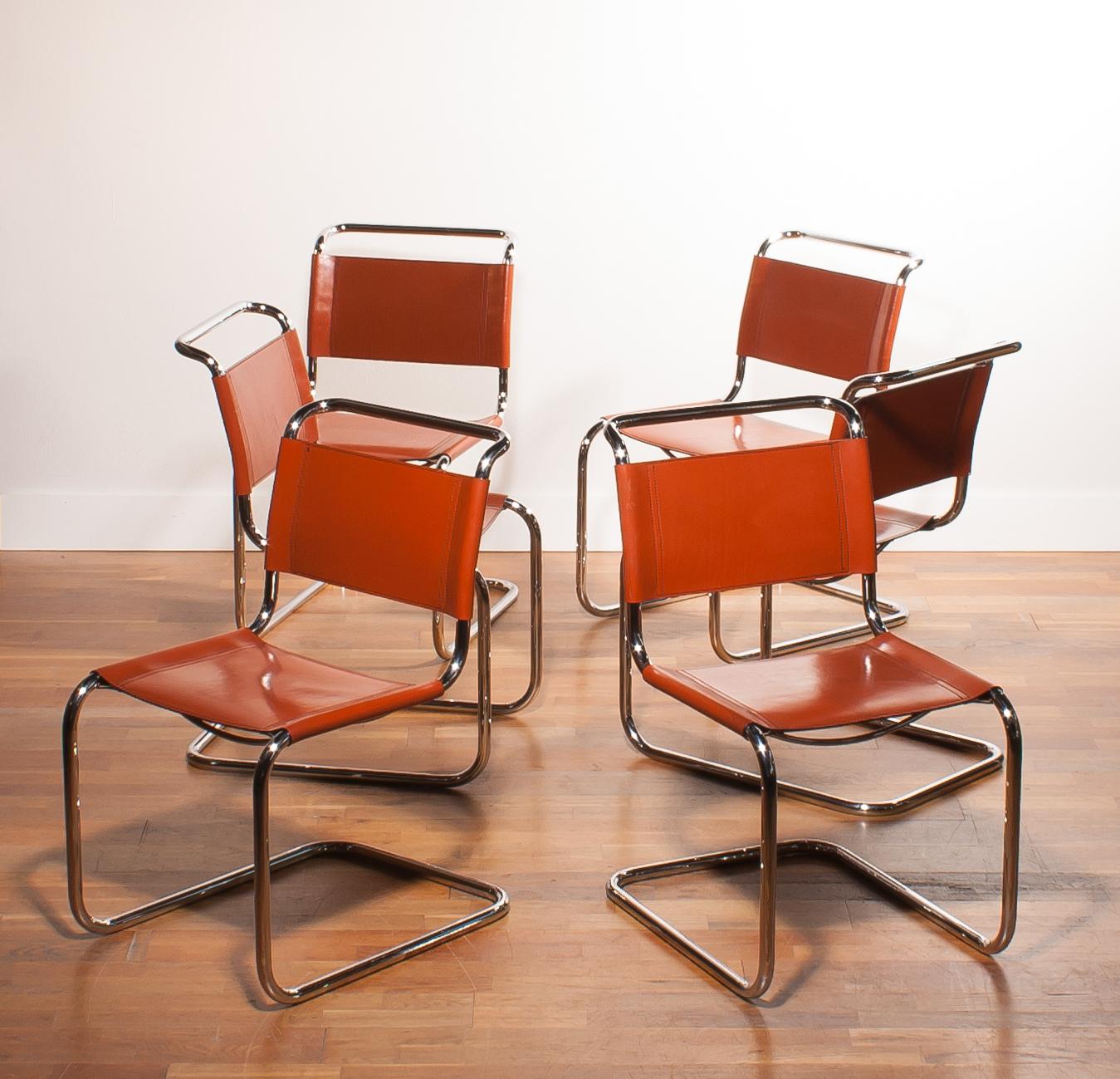 A beautiful set of six dining chairs designed by Mart Stam for Fasem.
These chairs have a cantilevered tubular metal frame with cognac saddle leather seating and backrest.
They are in a wonderful condition.
The chairs are marked with 'Fasem