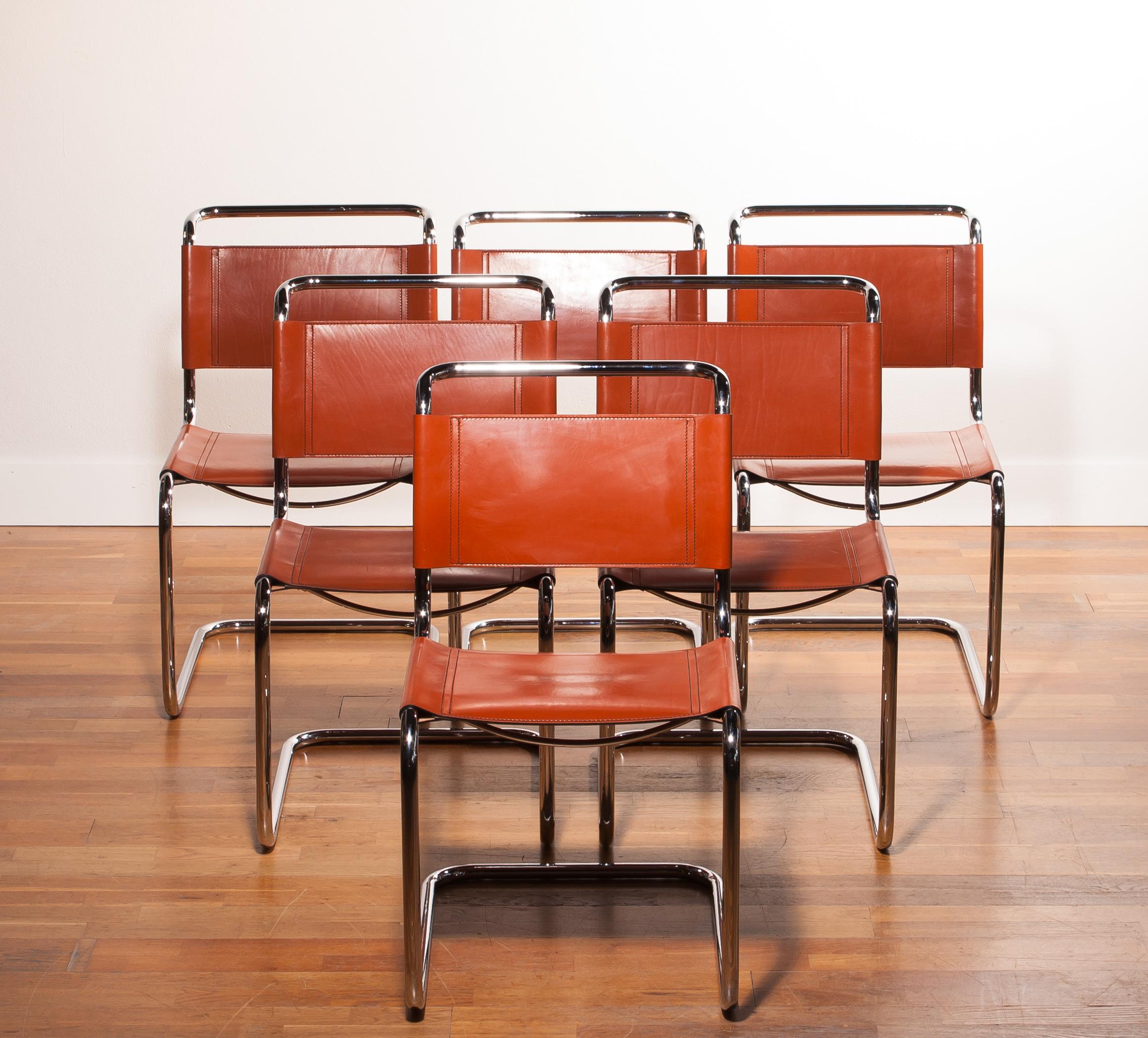 A beautiful set of six dining chairs designed by Mart Stam for Fasem.
These chairs have a cantilevered tubular metal frame with cognac saddle leather seating and backrest.
They are in a wonderful condition.
The chairs are marked with 'Fasem