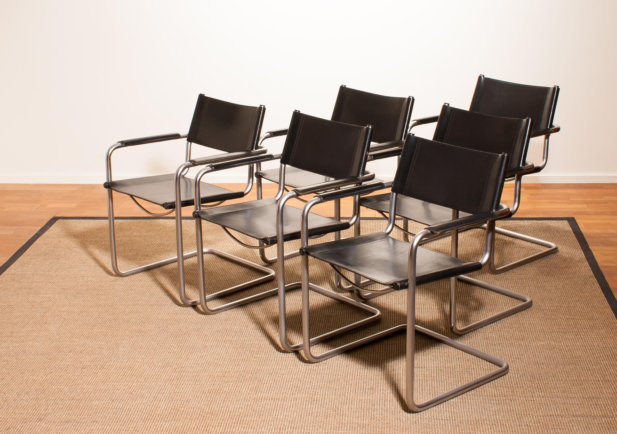 A beautiful set of six dining chairs made by Matteo Grassi, Italy.
The chairs have tubular titanium look steel frames with sturdy black leather seating and backrest.
They are signed on the back of the backrest.
The chairs are in a very nice