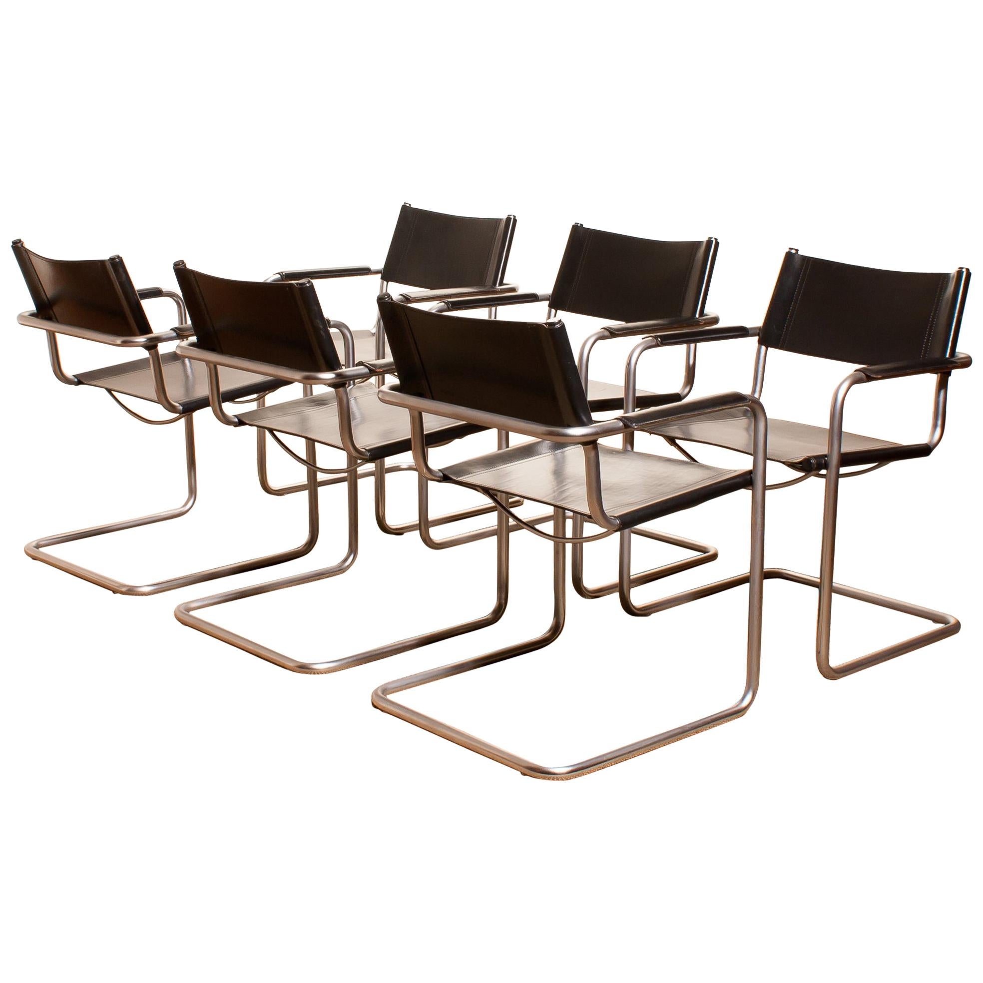 A beautiful set of six dining chairs made by Matteo Grassi, Italy.
The chairs have tubular titanium look steel frames with sturdy black leather seating and backrest.
They are signed on the back of the backrest.
The chairs are in very nice