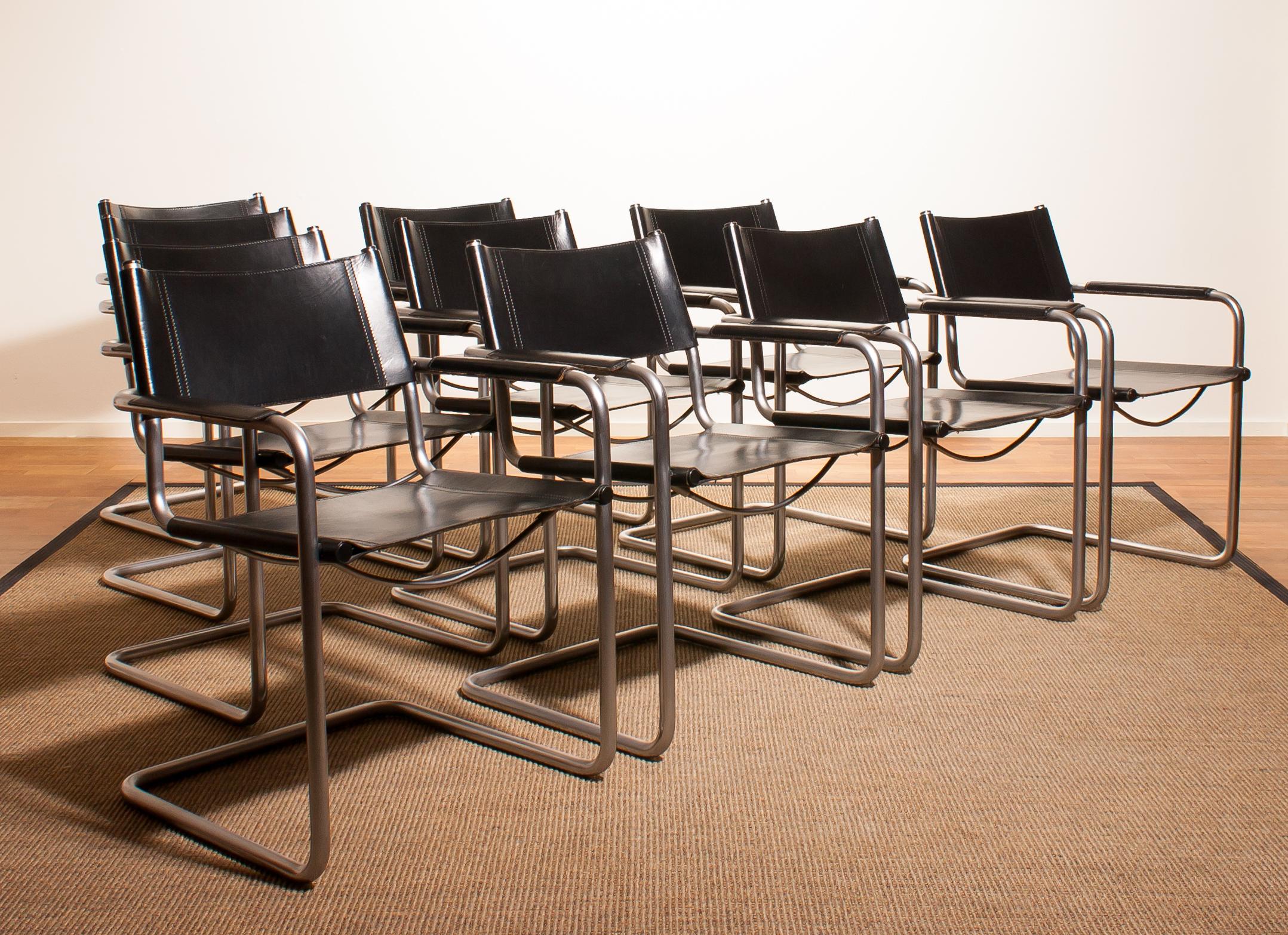 A beautiful set of ten dining chairs made by Matteo Grassi, Italy.
The chairs have tubular titanium look steel frames with sturdy black leather seating and back and armrest.
They are signed on the back of the backrest.
The chairs are in a very