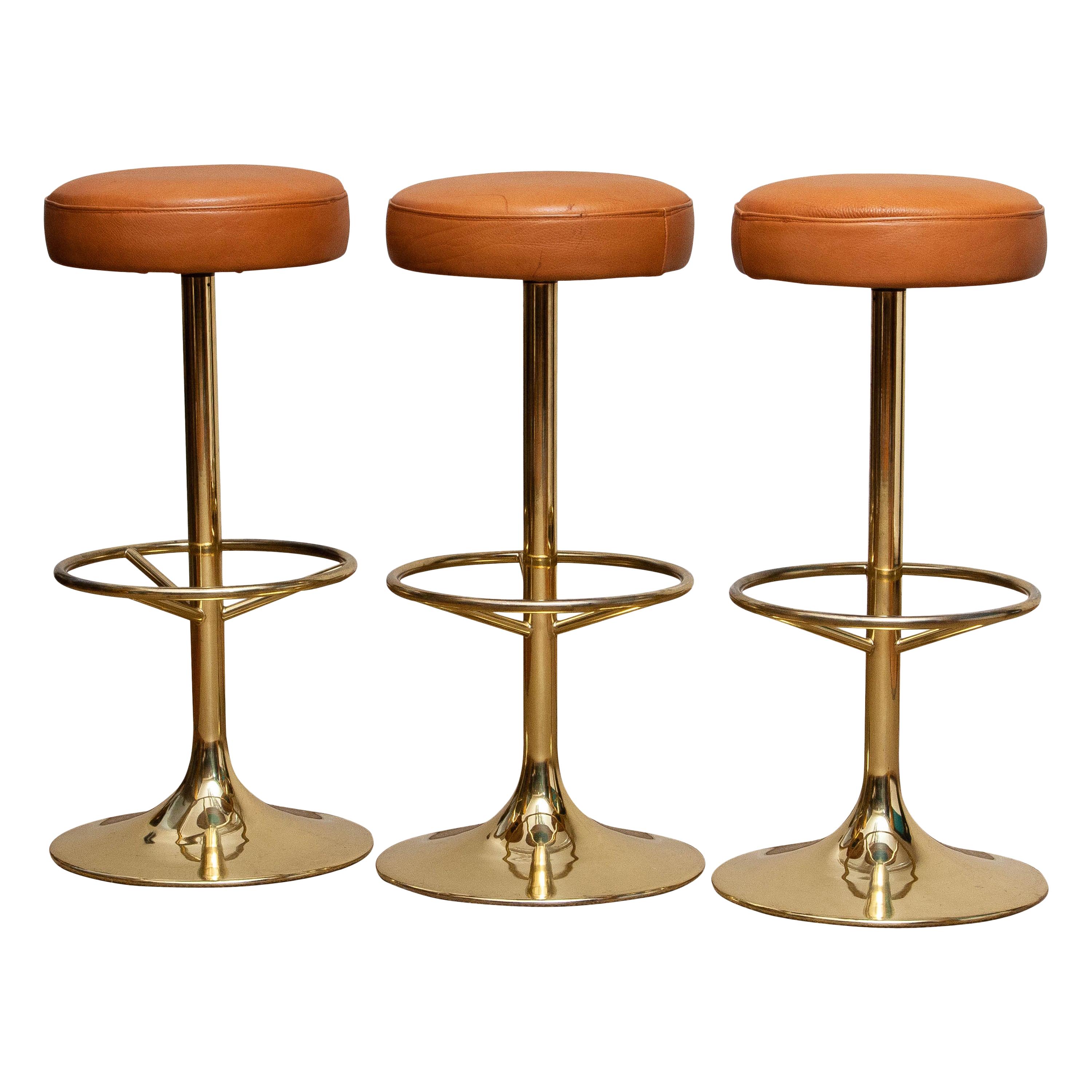 A magnificent set of three bar stools designed by Börje Johanson, Johanson Design, for Markaryd, Sweden.
Upholstered with cognac leather.
Overall condition is good.

Period: 1970s.
 