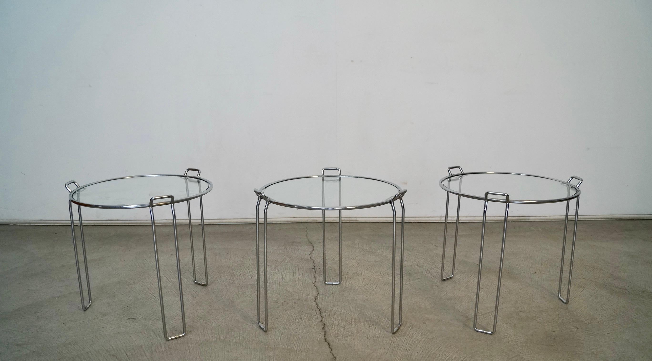 Vintage original Midcentury Modern nesting tables for sale. Set of 3 in chrome, and manufactured in the 1970's by Saporiti. These were made in Italy, and have a beautiful chrome frame with a glass inset. They are stackable, and beautiful end tables