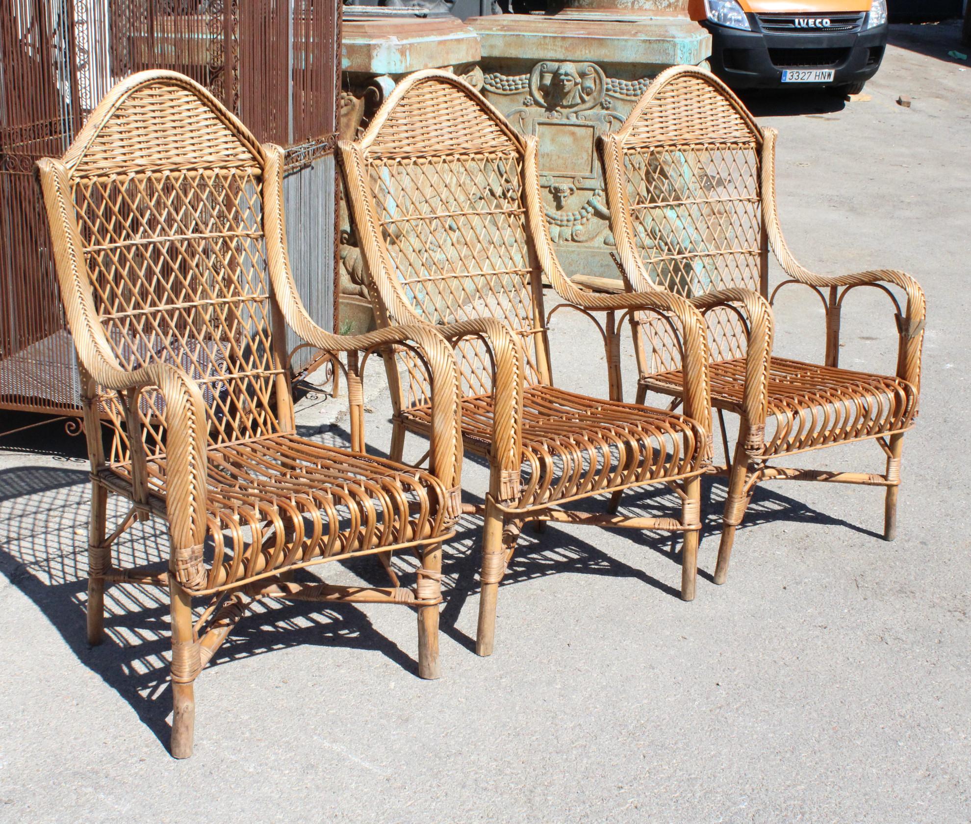 1970s set of three Spanish bamboo and lazed rattan armchairs.