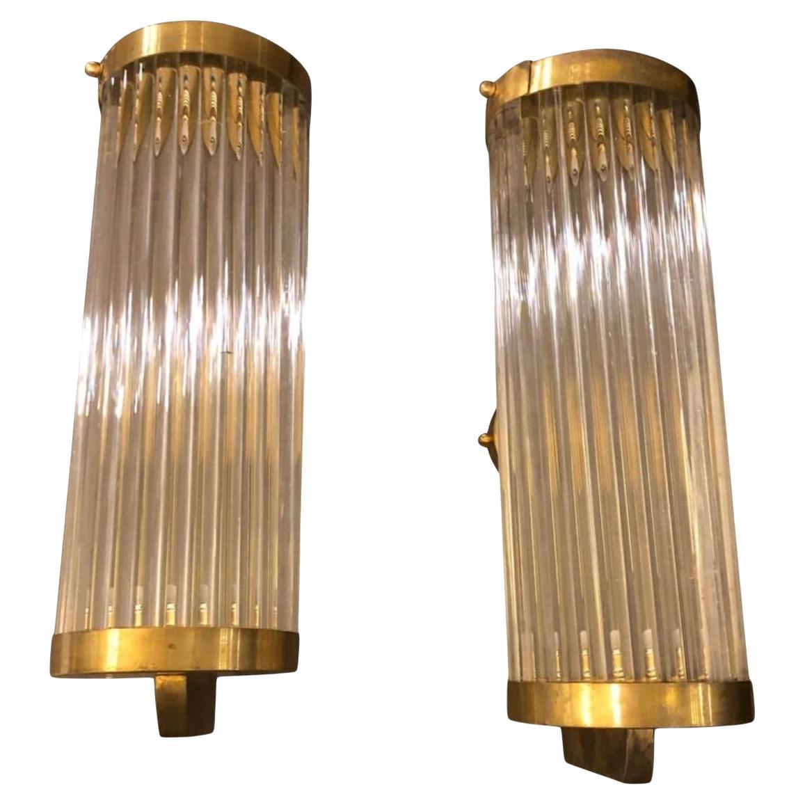 Stylish wall sconces made in Italy in the 1970s, solid glass tubes are in perfect conditions, brass it's in original patina. They have a system to be able to remove the glasses to clean them. Fully restored electrical parts, they work 110-240 volts