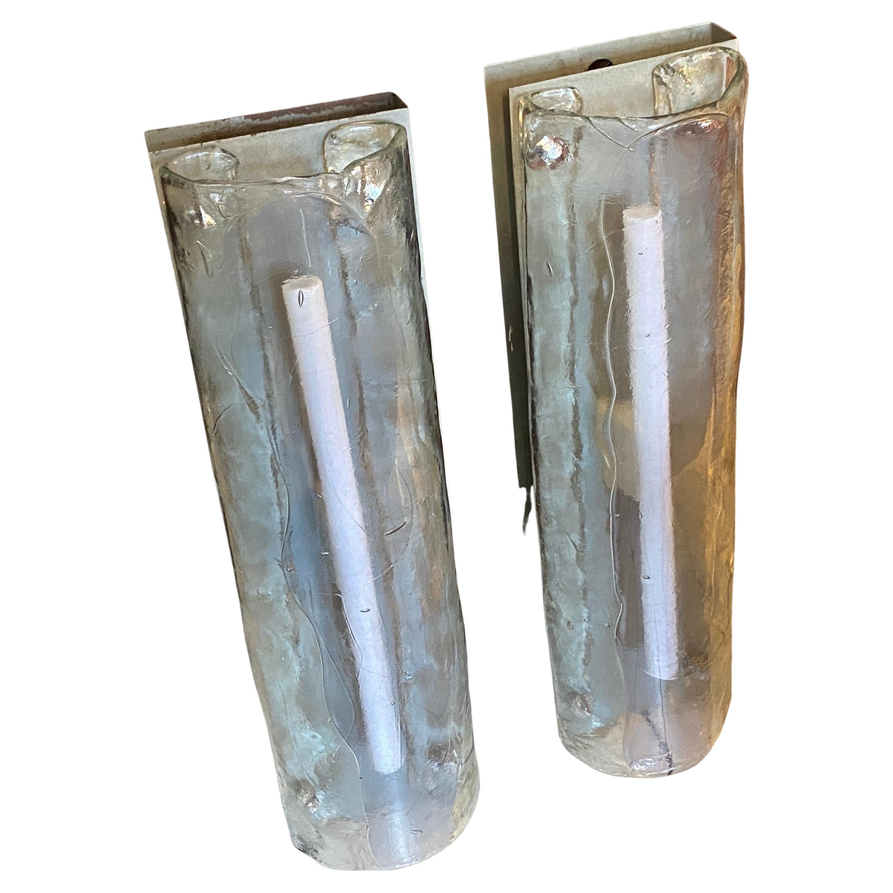 A pair of murano glass big wall sconces designed and manufactured in Italy by Mazzega in the Space Age era. The transparent heavy glass are in perfect condition, it works 110-250 volts and need two neon.