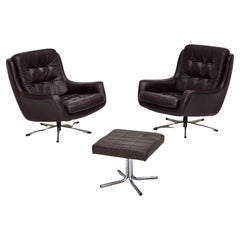 Vintage 1970s, set of two swivel lounge chairs with footstool, leather.