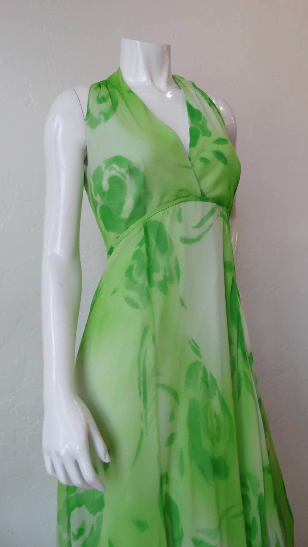 The most adorable 1970s maxi dress from costumer turned ready to wear designer Shannon Rodgers! Made of a rose printed green and white chiffon fabric in a flattering maxi silhouette. Halter-esque neckline with empire waistline just below the bust.