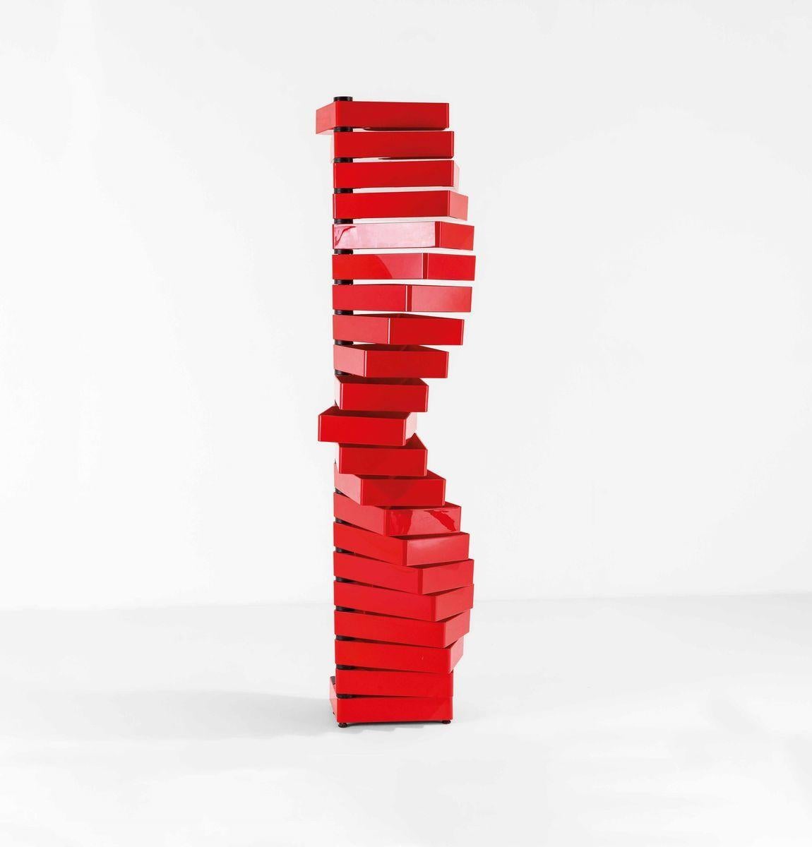 The “Revolving Cabinet” is a striking and unconventional chest of drawers designed by Japanese master Shiro Kuramata for the Italian Cappellini around 1970. This iconic piece consists of a vertical vivid red steel tube supporting 20 bright ABS